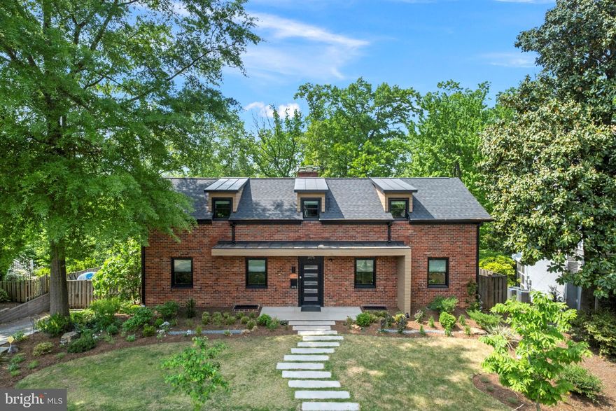 New Price! Exceptional residence seamlessly blends contemporary design with classic Arts & Crafts architecture in this inviting Lyon Village / Clarendon home. Nestled on a .26-acre  lot, backing to trees, this residence provides 3-fully finished levels with 4,000 square feet of living space. Serenity and privacy just 0.6 miles from the Clarendon Metro and the vibrant urban core of Arlington’s most coveted neighborhood. A comprehensive renovation in 2021–2022 brought transformative updates: brand new kitchen, new roof, all-new systems and windows, stylish upper-level shed dormer addition, wide plank white oak flooring on the main level, whole-house generator, and a dramatic reimagining of both the façade and interiors to reflect a contemporary sensibility. Inside, discover expansive, light-filled living spaces ideally suited for elegant entertaining and effortless daily living. A southeastern front exposure floods the formal living and dining rooms, and adjacent office, with natural light. Striking fireplace and built-in display shelving add character, while custom blinds provide flexibility between full or filtered light. The office offers a quiet workspace, and the rear family room impresses with soaring beamed ceilings, a second fireplace, custom built-ins, a designer bar with horizontal tiling, and windows overlooking lush yard. The chef’s kitchen is a bold interplay of black and white tones, anchored by a waterfall peninsula with seating and storage, ideal for casual dining or hosting. Top-tier appliances include Thermador cooktop, hood, wall oven, convection microwave; Bosch dishwasher; and sleek Fisher & Paykel refrigerator drawer. Floating shelves, spacious pantry, pot rack, and custom cabinetry complete this thoughtfully designed and highly functional culinary space. A main-level bedroom with vaulted ceiling enjoys tranquil views of rear yard. A full bath adjoining the bedroom ensures flexibility for guests or multigenerational living.  A curved staircase leads upstairs to a charming landing and sitting area. Two oversized bedrooms share full bath, and offer walk-in closets and custom roman shades by Dan Kugler. One bedroom features an expanded dormer with standing seam metal roof and oversized windows that frame backyard and treetop views. Finished lower level adds flexibility: spacious recreation room features third fireplace, fourth bedroom currently configured as a home gym, access to attached garage, and large laundry room with built-in shelving and more storage. So much storage and utility space ensure convenience and functionality. Unparalleled outdoor living! Over 2,000 square feet of terraces and decking surround a heated saltwater pool with tiered waterfall, circular firepit and seating, grilling and dining areas, and even a ping pong table. The dining area sits next to lovely Hinoki Cypress, ideal for seasonal dining. The tiered vegetable garden planted and already enjoying summer bounty. The lushly landscaped planting beds, designed by a landscape architect, feature peonies, hydrangeas and seasonal highlights, as well as perennial grapes, fig tree and asparagus. Every outdoor space reflects the same thoughtful attention to detail found inside home. All of this is located just two blocks from Lyon Village Park—with its playground, splash park, tennis and basketball courts—and only a short stroll to Clarendon’s shopping, dining, entertaining, metro and major commuter routes. Year-round fun awaits the new owner, making this singular offering in sought-after Lyon Village not only a private sanctuary, but the perfect place to enjoy the seasons to their fullest. A true retreat in the heart of it all.