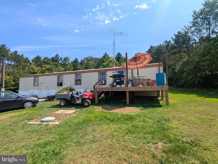 2 Acres with mobile home and plenty of storage sheds to make your own.  Home does need some repairs.