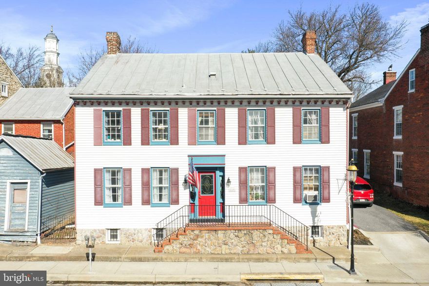 This All-American, Main Street home is a Classic Colonial offering 3 finished levels with 6 bedrooms and 4.5 bathrooms and a cottage. House features beautiful original hardwood flooring. Large country kitchen. Separate laundry room.  Upper level porch views of scenic vista and mountains. Front private parking for two. Private parking area for six vehicles in rear with walkway through well-manicured yard to entrance of home. Close to Mount St Mary's University, The National Shrine Grotto, Rt 15 and Gettysburg PA. This home is sold turn-key furnished.