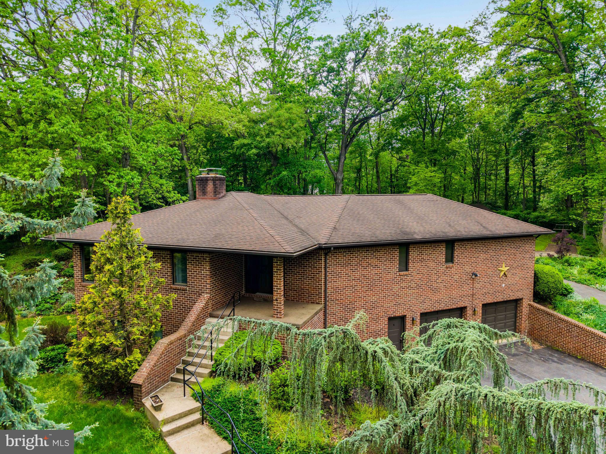 Your private oasis awaits! Experience the peaceful and relaxing ambiance offered by this 54+ acre country property, featuring a beautifully maintained and uniquely-designed 3 Bedroom, 2.5 Bath brick raised rancher. The main level features a formal Living Room with brick fireplace and Dining Room, both with access to the bright and airy Sunroom with beautiful nature views. A generously-sized Kitchen with dining area offers an abundance of cabinets featuring a desk/work area and pantry cabinet. The Kitchen also features a convenient center island, Corian counters, tiled backsplash, double ovens, all of which are sure to please the culinary enthusiast. The Primary Ensuite is designed with a quaint sitting room/office, full bath with expansive double vanity, whirlpool tub, shower, and spacious walk-in closet. This ensuite has access to the screened-in porch overlooking the rear yard and is the perfect place for morning coffee or relaxing with a good book. The Laundry Room with utility sink, and a Powder Room complete the main floor. The partially exposed finished lower level adds additional living space and includes an expansive Family Room with a wet bar and handsome brick fireplace adding warmth and character. The Family Room accesses a slate patio overlooking the side yard. 2 additional Bedrooms and full bath as well as a large cedar-lined closet with tile floor complete the lower level. An over-sized 2-car garage, and a 14' x 12' utility shed provide added space for storage. Don’t miss this rare opportunity - schedule your showing today and experience the peacefulness and privacy this property offers. Conveniently located to area highways with easy access to amenities yet secluded enough for total tranquility. Truly a must-see home!