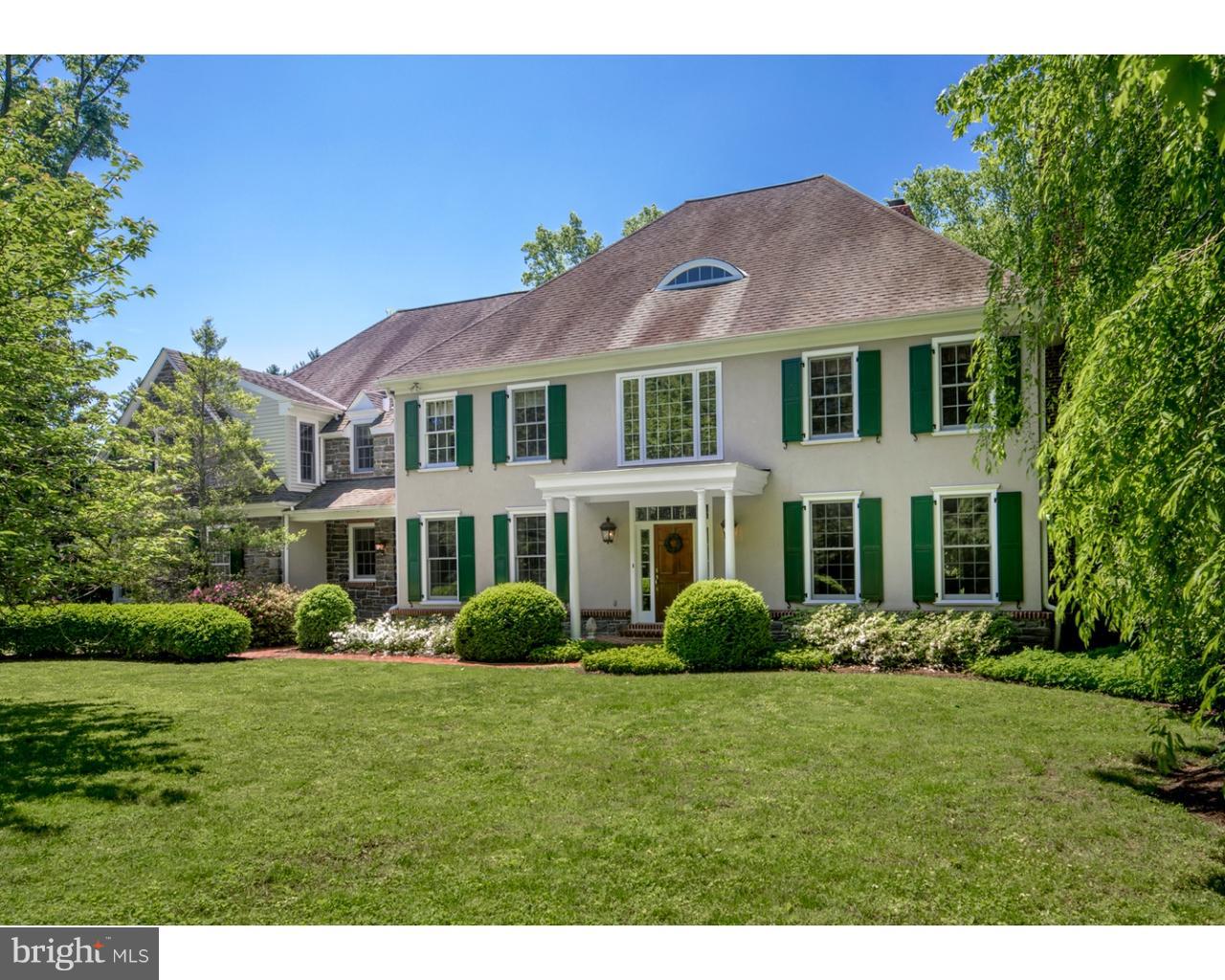 Set at the end of a long, private lane, this wonderful 5 bedroom 4.2 bath home is a true charmer, located minutes from the train, downtown Bryn Mawr, Suburban Square, and all that the Main Line has to offer. Pristine landscaping with mature plantings and trees grace the flat front yard and spacious rear yard where all can safely play while you watch from the flagstone patio. Out in front, a brick walkway leads to a charming covered entryway. Beyond the beautiful wood main door is a towering light-bathed center hall foyer graced by hardwood floors, lovely millwork, a commanding wood staircase that ascends to an open landing, 2 coat closets and a powder room. The formal living room adorned with crown moldings and a marble fireplace provides comfort and elegance for entertaining. Pocket doors lead to a wood-clad office with built-in cherry cabinetry and matching cherry desk for sharing cocktails or reading quietly. Glass French doors open to the peaceful covered porch. The formal dining room is equally elegant and can easily accommodate large gatherings. Take off your shoes and relax in the generously-sized family room with a stone wood-burning fireplace, wet bar, and glass doors to the Zen patio. The stunning chef's kitchen featuring cherry wood cabinetry, granite countertops and center island, and Thermador stainless steel appliances is the go-to gathering spot for the family, and an excellent backdrop for serving buffet-style meals. The open breakfast room brightened by a glass wall fits even more people and spills out to the patio as well. A mudroom with an outside entrance, entry to the attached garage and rear stairs to the 2nd floor optimize convenience on this level. Upstairs 5 well-proportioned bedrooms and 4 full baths await, including the dreamy master suite with a vaulted ceiling, gas fireplace, walk-in closet, large sitting room with picturesque views, and marble bath. Two additional bedrooms are also en-suite, and the 2 others share a Jack and Jill bath. A convenient laundry room completes the comfort. Other highlights of the home are a walk-up attic and an unfinished lower level with high ceilings waiting for your touch!