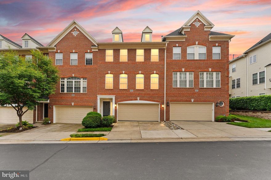 Welcome to this beautifully maintained three-level brick-front townhome condominium featuring a two-car front-loading garage and an open, light-filled floor plan.

The entry level offers a spacious family room, a convenient half bath, and direct access to the two-car front-loading garage—ideal for a home office, recreation room, or additional living space.

The second level is the heart of the home, featuring hardwood floors throughout and an open-concept layout designed for both everyday living and entertaining. The gourmet kitchen boasts white cabinetry, granite countertops, stainless steel appliances, and a sunny eat-in area. A separate dining room with crown molding and chair rail adds an elegant touch for formal gatherings. Just off the kitchen, the dramatic two-story family room is filled with natural light and opens to a private deck, perfect for outdoor dining or relaxing. The spacious primary suite is also located on this level and includes a custom walk-in closet and a luxurious ensuite bath with dual vanities, a soaking tub, and a separate shower.

The upper level features a versatile loft area overlooking the family room below, along with two additional bedrooms, a full hall bath, and a conveniently located laundry room.

Located in the highly sought-after Lowes Island community and part of Cascade, residents enjoy access to five swimming pools, numerous parks, tennis courts, and close proximity to Algonkian Regional Park. With easy access to Route 7 and Route 28, this exceptional home offers the perfect combination of comfort, style, and convenience.