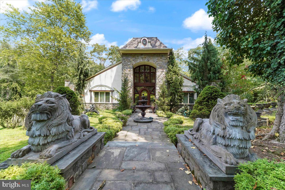 Welcome to this majestic French Contemporary Retro Estate home on a fabulous level 2.76 acre lot overlooking the Springton Reservoir. The views are spectacular from the 2000+ sq. ft Veranda which surrounds this home---perfect for entertaining both outside & inside. The grand main entrance opens to a
large entrance hall with gleaming hardwood floors, high ceilings and exquisite mahogany doors. A large great room area boasts. a 2-sided fireplace, a grand Dining Room (currently used as a music room); a spacious Kitchen with reservoir views opens to Dining Area with 2-sided fireplace and door to the Veranda with Hot Tub. The main level also offers a Powder Room, Sun Room and Laundry Room. Enjoy the first floor Primary Bedroom- Suite-very Romantic with doors opening to the Veranda, a 2-sided Fireplace (to be enjoyed in the Bedroom Suite or the custom Bathroom), 2 oversized walk-in closets and a Primary Bath with a large walk-in Shower, Jacuzzi Tub, his & her sinks & beautiful Mosaic Floor.. There are 2 additional Bedrooms and large Hall Bath as well. Take the Staircase to the large Loft which adds entertaining space galore in your own custom Billiard Suite!
The lower level boasts almost 2000 sq. feet of finished space which includes a Bedroom, a full Bath, a Sitting Room and a Great Room that is walkout to the beautiful grounds, There is approximately 2000 sq. ft of additional currently unfinished space with a massive Cedar Closet.
Walk out to the gorgeous grounds ! There is a 3.5 car oversized garage and beautiful fountains and much much more. This is truly one of the nicest properties in the area--a must see!! Close to Ridley Creek State Park, local hospitals, shopping & restaurants, Located in the Rose Tree Media School District !