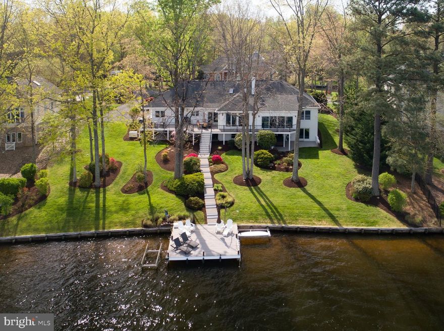 Exquisite Waterfront Living in Prestigious Fawn Lake

Welcome to a masterfully renovated waterfront estate, nestled on a peaceful cul-de-sac within the exclusive, gated community of Fawn Lake. Offering nearly 6,000 square feet of sophisticated living space, this extraordinary home has been thoughtfully enhanced with over $300,000 in high-end upgrades, creating a rare turnkey opportunity for the most discerning buyer.

From the moment you arrive, you are greeted by newly designed Craftsman-style columns, setting the tone for the elegance that awaits inside. The residence showcases solid maple hardwood floors throughout the main level, soaring 9-foot ceilings, and exquisite crown molding accentuating every living area and bedroom. A breathtaking brick fireplace with gas logs serves as the centerpiece of the grand great room offering a cozy, yet grand atmosphere. The formal dining room is adorned with a tray ceiling, ambient uplighting, chair rail, and intricate molding, creating a perfect setting for intimate gatherings. 

The gourmet kitchen is a chef’s dream, featuring Maple flooring, gleaming granite countertops, and a suite of premium appliances including a propane stove. Large windows allow natural light to flood the space while providing uninterrupted views of the water. The sunroom, with private access to the outdoor deck, serves as a perfect retreat for relaxation or intimate gatherings. Not mentioning the incredibly beautiful and relaxing sunsets would be a disservice to this home.

When retreating to your luxurious primary suite, this home offers the ultimate in waterfront living. It’s a perfect blend of relaxation, recreation, and elegance. The primary suite is a true sanctuary, featuring walk-in closets and private access to the sunroom, offering sweeping lake views. The remodeled owner’s bath is spa-inspired, with a frameless glass tile shower, a freestanding soaking tub, a dual-sink quartz vanity, and new lighting fixtures. 

The lower level is fully finished, with daylight windows and porcelain flooring providing ample space for recreation or relaxation. A brand new fully appointed bar has a 72-inch glass-door under-counter refrigerator, a two-zone wine chiller, a gourmet cube ice maker and glass shelves to show off your glassware. A refined bourbon tasting area offers connoisseurs an elegant space for enjoyment.
High-End Features & Updates
Equipped with the finest of amenities, a Generac Generator (Wi-Fi enabled) that powers 90% of the house ensures no loss of power to your waterfront, country retreat. The oversized 3-car garage includes built-in shelving, a utility sink, and rear yard access. Throughout the home, all top of the line Anderson Windows and Doors were replaced, top to bottom.

A Lifestyle of Luxury
This home offers peace and tranquility, while still being close to the community's world-class amenities. The deep-water dock, with a newly updated bulkhead top surface (2020), provides direct access to the lake, making it ideal for boating enthusiasts. Whether you're relaxing on the front porch enjoying the front lake view, entertaining on the expansive rear deck, or enjoying a sunset from the dock, the views are simply unparalleled. Seriously....the views are unmatched, especially the sunsets.This extraordinary waterfront estate is a rare opportunity to own in one of the region’s most prestigious communities. 

Unmatched Community Amenities
Fawn Lake is renowned for its outstanding amenities, including a private marina, a lakeside beach, Clay tennis courts, a fitness center, walking trails, community clubhouse, pickleball courts, dog park. The Arnold Palmer-designed golf course is a highlight for golf enthusiasts and you can top your day off at one of the 2 restaurants on site. This peaceful, country club community is just minutes from the charming town of Fredericksburg, offering easy access to local wineries, breweries, and scenic farmland.