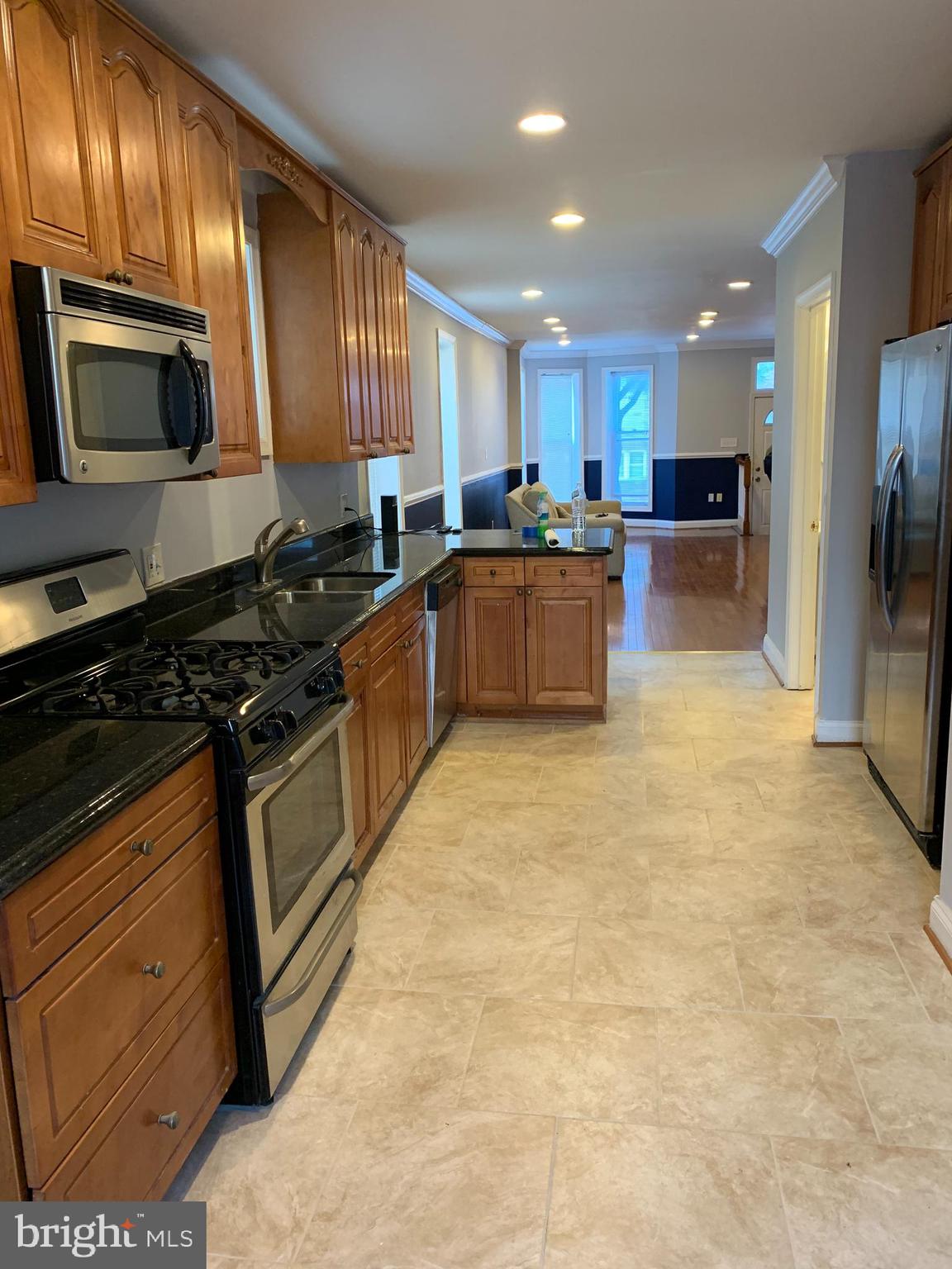 This beautifully renovated 3-bedroom, 2.5-bath home in the desirable Reservoir Hill neighborhood combines modern updates with classic charm. The main level features exposed brick walls, hardwood floors, recessed lighting, and crown molding, creating a warm and inviting atmosphere. The spacious eat-in kitchen is equipped with granite countertops and stainless steel appliances, blending style and functionality. Upstairs, the master bedroom includes a private en-suite bath, while two additional bedrooms share the hall bath. Outside, enjoy a private, fenced-in yard and off-street parking. The large unfinished basement provides ample storage or potential for customization. With central A/C, a main-level washer/dryer, and a prime location just minutes from downtown Baltimore, Druid Hill Park, Coppin State University, MICA, the subway, and other public transportation options, this home offers both comfort and convenience.