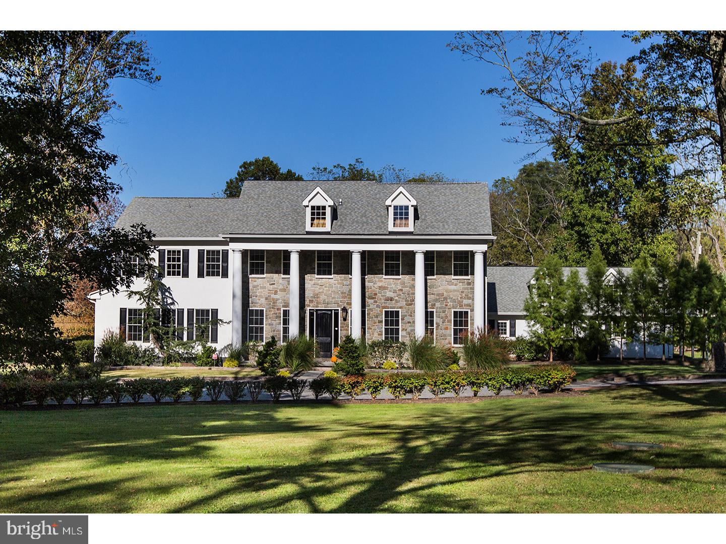 Set on over 12 acres of lush, park-like grounds and overlooking a serene pond, this extraordinary estate offers rare privacy and refined living. Backing to hundreds of protected, deed-restricted acres, the setting is both peaceful and picturesque.
The main residence seamlessly blends old-world character with today’s finest materials and modern conveniences. Original architectural elements have been thoughtfully repurposed throughout, honoring the home’s history while enhancing its eco-conscious design. Much of the wood used in the interiors was reclaimed from the original homestead and is believed to pre-date Columbus, adding a sense of timeless authenticity to the space.
The open and flexible floor plan is ideal for modern living, with hand-hewn wood details and radiant floor heating throughout the first level. The sun-drenched interiors are framed by expansive windows offering uninterrupted, private views of the surrounding landscape. At the heart of the home is a state-of-the-art chef’s kitchen with top-of-the-line appliances, designed for both everyday cooking and elegant entertaining.
The main house features six en suite bedrooms, indoor and outdoor fireplaces, a fully integrated smart home system, and a private home theatre. A charming columned front porch adds to the home’s classic appeal.
An attached wing offers its own separate kitchen, living/dining area, laundry room, three bedrooms, and two full baths—perfect for extended family, guests, or staff quarters, and can be closed off for privacy if desired. Additionally, a beautifully restored antique guest cottage offers further flexibility and charm.
A separate barn-style building provides exceptional space for a car collection, gym, or large-scale storage, while a three-car garage is conveniently connected to the main house via a covered breezeway.
The outdoor living spaces are equally impressive, featuring a covered terrace with an outdoor fireplace and multiple seating and dining areas. These overlook the beautifully designed heated saltwater pool. Ample parking and dual access from front and rear driveways make entertaining effortless.
Located in desirable New Hope-Solebury, just 70 minutes to New York City, one hour to Philadelphia, and 35 minutes to Princeton.