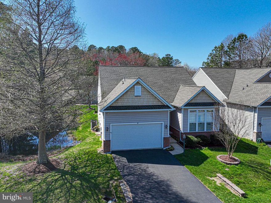 Discover this stunning residence in The Parke at Ocean Pines, an esteemed 55+ community just minutes away from the beautiful beaches of Assateague and Ocean City, Maryland. This highly desirable Osprey model three-bedroom, two-bath home features elegant 10 foot ceilings, crown molding, hardwood and ceramic tile flooring. The kitchen showcase granite countertops, high end LG and Bosch appliances and a breakfast bar area perfect venue for entertaining. Enjoy the warmth of see through fireplace in an expanded sunroom with tasteful tile flooring, designer window treatments, replacement Pella windows complimented by decorative stain glass artwork on transom windows. Step outside to a spacious back trek deck equipped with a patio, perfect for relaxing after a long day at the beach. Relax in your primary suite boasts  trey ceilings, double crown molding and huge walk in closet.  Additional highlights of this home include a new roof in 2020, a tankless water heater, and energy-efficient windows adorned with plantation shutters. The insulated attic, fixed air exchangers, encapsulated crawlspace, and a new sump pump with a general air dehumidifier ensure a comfortable living environment year-round. Home is complete landscaped front yard with beautiful stonework, culverts and flower beds. Full enhancement list of home upgrades can be found in the document section. All amenties of Ocean Pines and the Parke await you for this summers enjoyment. This home is competitively priced for a quick sale so call now for your private tour appointment.