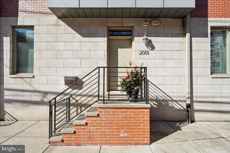 Step into this stunning and spacious first floor bi-level home, the largest in a modern three-unit building. With its own private entrance and an abundance of natural sunlight, this home offers privacy and warmth.  Though perhaps the most surprising feature are the two dedicated on-site parking spaces included with the property. 

The main level features a beautifully designed open space highlighted by a kitchen with a sleek breakfast bar, white quartz countertops, a stylish stone mosaic backsplash, stainless steel appliances, and rich cherry cabinets. Adjacent is a well proportioned living room with 9’ ceilings and an abundance of windows, all with custom window treatments.  It's a perfect space for entertaining or just relaxing after a long day, and has a convenient separate side entrance to the private driveway outside. This level also includes a sun drenched bedroom with ensuite bath.  The bath, recently updated with a new shower, is complimented by plenty of closet space, making this area of the home bright and convenient. 

The lower level includes the primary bedroom with en-suite bath, a secondary bedroom with full bath and a large laundry room. The main bedroom suite includes new carpet, motorized shades, generous closet space, and a redesigned en-suite bathroom. The second bedroom is equally impressive, featuring oversized windows that flood the space with natural light. Thanks to recently replaced windows, this level remains peaceful and quiet.  The second full bathroom is adjacent to the bedroom. Also found on this level is the laundry room, with a full size stackable washer and dryer, and additional storage.

With two years left on tax abatement, low HOA fees, and two off-street parking spaces, this home is a rare find. Don't miss the opportunity to own this exceptional unit in a well-maintained building!