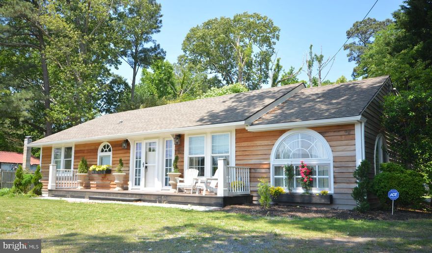 Public sewer coming soon & will be complete for new buyer! Custom designed and completely renovated one level home with outdoor living and huge pole barn for all your toys.  Attractive cedar siding, palladium windows and creative design makes this  coastal/cottage one of a kind. Beautiful front views of farmland yet so close to historic Easton, St. Michaels and all commuter routes.  Hardwood floors, a lovely primary suite with patio and second ensuite primary with vaulted ceiling, exposed beams and beautiful custom full bath.  Expansive rear deck for entertaining. Huge yard with a 30' by 30' pole barn for your boat/RV/car storage plus a charming gardeners shed.  Warm and rich Mediterranean style kitchen with breakfast/sitting room and wall of sliding doors to huge wood deck and private treed back yard and gardens. Light filled open concept in living and dining room  with barn doors to step-down kitchen.  Gated access. Please make appointment before entering property.