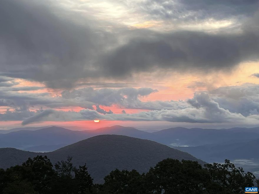 Gorgeously updated, amazingly remodeled and expanded kitchen + huge pantry! Imagine sipping your morning coffee on your private deck, surrounded by nature's beauty and breathtaking sunrises from this immaculate mid-level 2-bedroom, 2-bath condo perched high on the ridgeline at Wintergreen Resort. This thoughtfully updated home features modern furnishings, LVP flooring, and a full-size washer and dryer, blending modern convenience with cozy mountain charm.  After an exhilarating day on the slopes, accessed via the nearby Highlands Express lift, relax around the inviting wood-burning fireplace. Stroll to the Mountain Inn along the Highlands Leisure Trail or enjoy a delicious meal right across the street at Fire and Frost. Visit the spa, pool, and fitness center, or take advantage of the nearby Devils Knob golf course, restaurant, and tennis/pickleball courts?all within walking distance. With just a few steps from your car to your front door, convenience meets comfort at every turn.  Meticulously maintained and used exclusively for personal enjoyment, not as a rental, this rare find offers year-round panoramic views and is ready to welcome you to your perfect mountain retreat! Grab it while you can!,Granite Counter,Wood Cabinets,Fireplace in Living Room