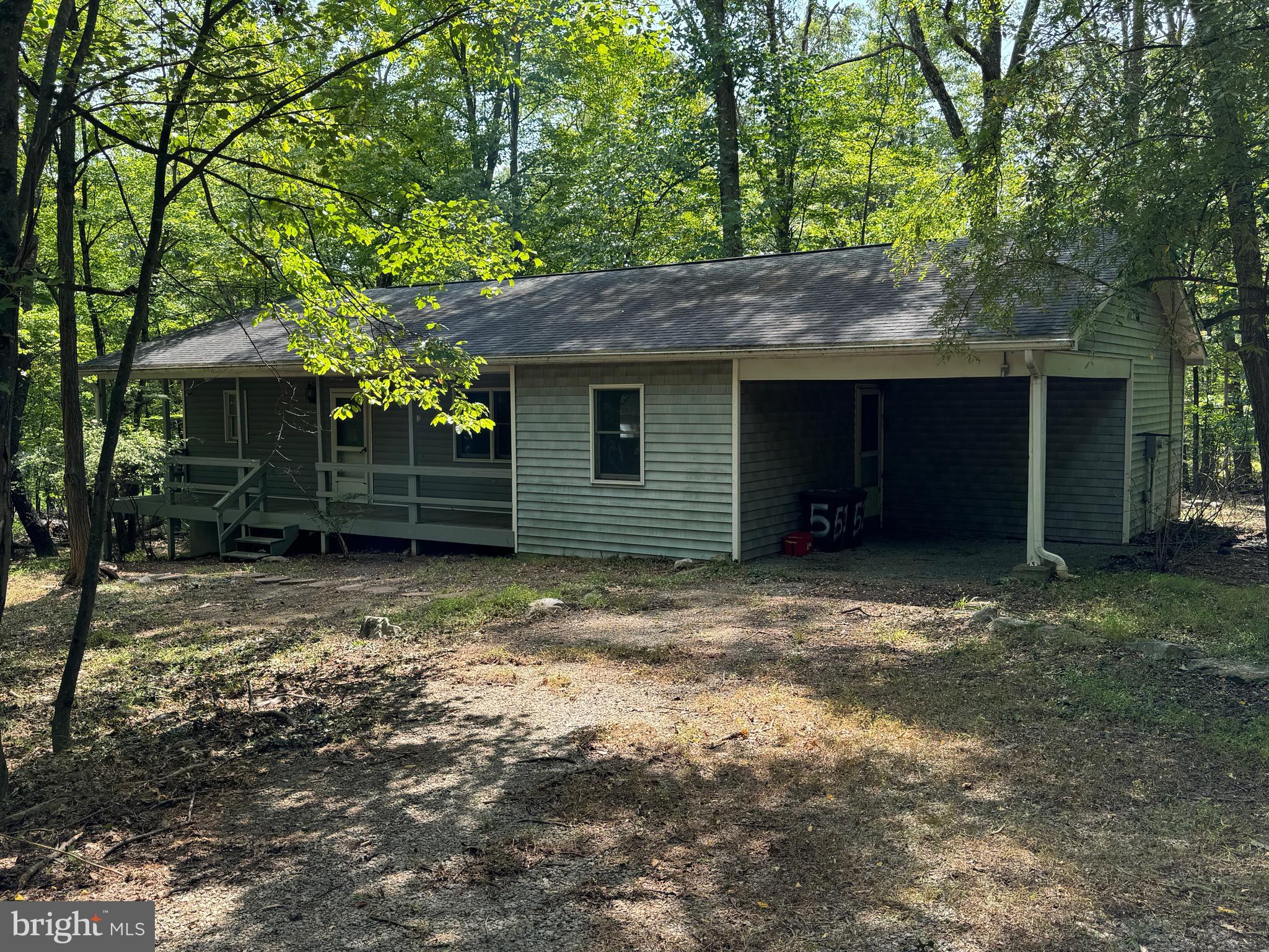 Looking for a ranch style home on 2.8 private wooded acres? Look no further! 2 large bedrooms, 2 full baths, enormous family room with hardwood floors and wood stove, nice sized eat in kitchen with plenty of cabinetry and dining area this country home offers tremendous opportunity and with a some TLC will make a dream home! The house sits off the road giving a feeling of privacy. Enjoy you covered front porch, large rear deck and oversized attached carport. HVAC updated in 2018. Don't miss out of this rare find!