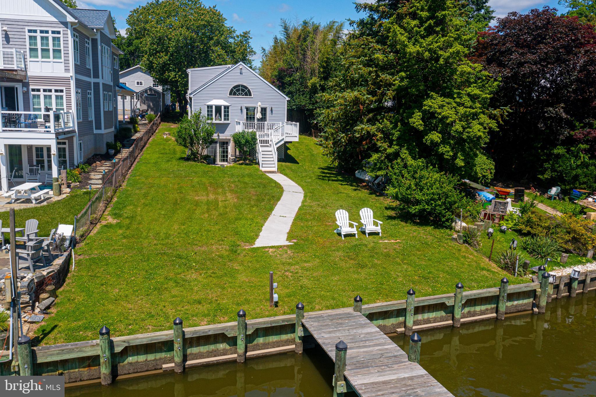 Welcome to 2328 Poplar Rd – A Waterfront Retreat with Deep, Protected Water and Modern Comforts Check out this beautifully updated 3-bedroom Waterfront home that offers the perfect balance of comfort, style, and Chesapeake Bay lifestyle. The main level features a primary bedroom and a full Bath, a remodeled island kitchen that flows effortlessly into the dining area, sitting room, and a vaulted-ceiling living room with great water views and sliders opening to your waterside composite deck ideal for morning coffee or a quiet evening cocktail while overlooking your large ‘front’ yard, new pier, new bulkhead and new Boat lift...and Sue Creek. Upstairs, you’ll find two additional bedrooms and a convenient half bath, perfect for guests or a growing family. The walk-out lower level provides a cozy family room with sliders to a private outdoor courtyard, a second half bath, laundry area, and generous open storage space. Outside, the property truly shines with an oversized 8+ car parking pad, a roadside shed, and a large level yard leading to your pier and boat lift all set on deep, protected water. No flood insurance required. Whether you’re boating, entertaining, or simply relaxing by the water, 2328 Poplar Rd offers plenty in Waterfront living on Sue Creek! **ALL FURNITURE IS INCLUDED**