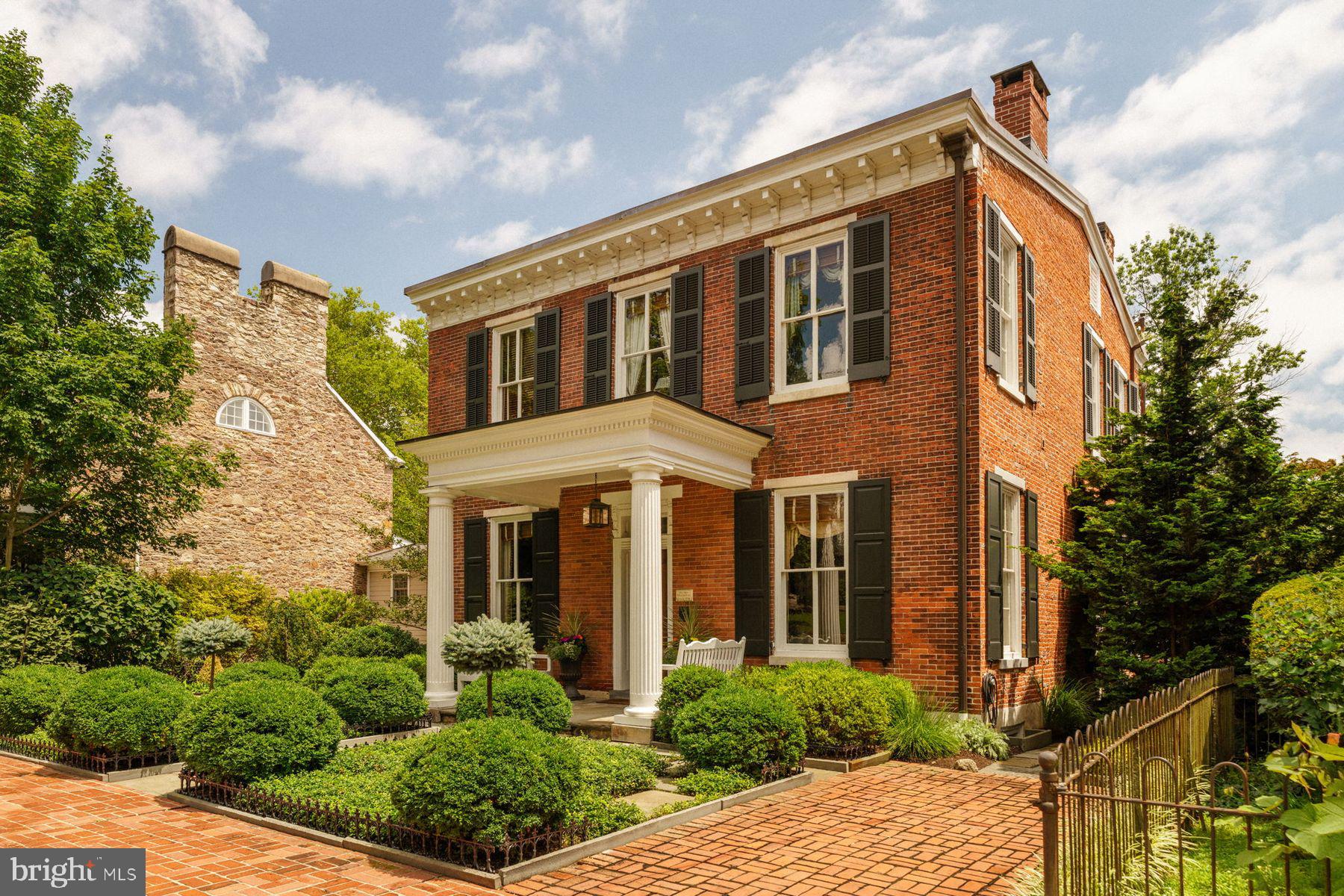Own a Piece of Doylestown History
A rare historic gem in the heart of Doylestown, this distinguished residence at 146 E. Court Street invites its next owner to become part of its enduring legacy. Built in 1856, the Silas Andrews House blends Federal-style elegance with a plethora of modern upgrades.. Featuring 4 bedrooms, 2.5 baths, and 3,334 sq. ft., the home offers soaring ceilings, double-parlor layout with pocket doors, fireplaces, and period-inspired finishes throughout.
Recent improvements include two enclosed, climate-controlled sun porches with radiant heat, a remodeled kitchen with Miele appliances and reconfigured island, whole-property professional landscaping with tiered gardens, antique brick walls, irrigation system, and custom pergola. Major system upgrades: new roof (2025), Bosch Combi boiler, whole-house generator, 2-zone HVAC, temperature-controlled wine cellar, EV charger, cedar shutters, and updated insulation.
146 E. Court Street is more than a home; it is a historical beauty with quiet sophistication. This residence offers a blend of architectural distinction with in-town living at its finest. Offering the rare combination of off-street parking and a walkable lifestyle, this home places you steps from the best of Doylestown. With the train station nearby, weekend getaways or an easy commute to Philadelphia are just moments away. Come discover the allure of this treasure in downtown Doylestown and embrace a life of elegance, comfort, and connection!