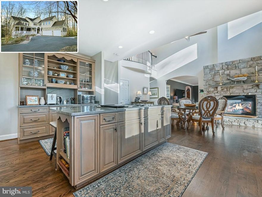 Welcome to 315 Kyle Road, a breathtaking waterfront estate graciously set on 3.8 acres just off the Severn River. This property is a rare offering in the current market: a private pier with 10 ft water depth on protected Old Place Creek, more than 6,800 SF of meticulously crafted and maintained living space, and ample acreage offering privacy and beautiful natural surroundings.
With five bedrooms and four-and-a-half baths, every corner of this home reflects unparalleled attention to detail and quality. The main level has multiple expansive living areas designed for entertaining or quiet relaxation. Upon entering, the space literally blooms from the two-story foyer; an elegant, curved staircase leads to an upstairs overlook or step into one of the main living areas. These include a formal living room with fireplace, a cozy library ideal for reading and reflection, and a sunroom surrounded by lush woods. The gracious, waterside family room flows easily to the formal dining room and kitchen. The gourmet kitchen is a culinary haven equipped with top-of-the-line appliances, luxurious finishes, and an open layout that will delight any chef or entertainer. It’s a beautiful combination of glass-fronted cabinets, open display shelves, and plenty of undercounter storage. The two-sided fireplace keeps both the kitchen and family room ambient during colder months. A waterside deck spans the width of the family room and kitchen, perfect for indoor-outdoor enjoyment. Gorgeous hardwood floors throughout the main level. For convenience, there is a 2nd staircase from the kitchen to the 2nd floor. And, in the warmer months, the wide front porch with ceiling fans has several seating and dining options.
At the top of the front staircase, you’ll enjoy an overlook to the great room below and out to the flowering trees through the front windows. The spacious primary suite serves as a relaxing retreat, featuring a sitting area with private balcony overlooking the water. The spa-like bathroom offers separate vanities, an oversize shower and a luxurious jetted tub, and there’s a huge walk-in closet. The second waterside bedroom has a private balcony and ample closet space. There is a full bath across the hall. Bedroom 3 is a large room with sitting area; it shares a bathroom with the 4th bedroom. The entire upstairs has beautiful hardwood floors. The windowed laundry room is also on this level.
The walk-out, lower level is an entertainer's dream, with a fabulous rec room that opens to the waterside patio. There’s a wet bar for hosting gatherings and lots of natural light. Guests and family will enjoy the proximity to the water, strolling down for a sundowner on the dock or an early morning kayak ride to watch the birds. The lower level also features a gym, a full bath, and a waterside bedroom that could be a dance studio. The utility room offers a significant amount of storage space.
Step outside to discover what makes this property so incredible. Whether relaxing on the front porch, enjoying the waterside deck and balconies, or hosting gatherings on the back patio, this property has something for everyone. The private dock, out of the chop of the Severn River, is perfect for boating enthusiasts and water activities. Run down to City Dock in your smaller craft, or head across the Bay to St. Michael’s for a weekend.  The expansive grounds are adorned with cherry trees (among others) and the spring blossoms are stupendous. The location of the home on the lot creates the utmost privacy. 
Severn Side Farm is a sought-after waterfront community consisting of a 60 acre peninsula with 20 home sites. Waterfrontage is on both the Severn River and Old Place Creek, a protected body of water that is called Fox Creek locally. The property is ideally located close to major commute routes to DC and Baltimore, or it’s a 20-minute drive to downtown Annapolis.