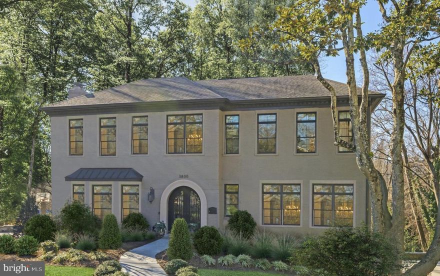 Discover the allure of 3800 52nd Street NW, a stunning architectural creation with exceptional design in prime Spring Valley location. Completely redesigned and rebuilt in 2016, this exquisite home is nestled on a one-third-acre lot and private cul-de-sac which features a striking exterior with painted brick and Pella windows with contrasting dark trim.  Upon entering through the arched glass and wrought iron double doors, you are greeted by a foyer with soaring ceilings and a dramatic staircase, setting the tone for over 5,500 square feet of gracious living space. A secluded office with double French doors is situated off the foyer, while the formal living and dining rooms opposite are adorned with beautiful crown moldings, chair rails, and shadow box details.

The main level includes 10' ceilings throughout and includes a gourmet kitchen that opens into an expansive informal living area. The family room, highlighted by custom millwork on accent wall and beamed ceiling, offers panoramic views and abundant natural light through a wall of windows overlooking the lush backyard. The kitchen, designed for both the avid cook and the entertainer, boasts extensive cabinetry, a large central island with seating, a commercial-grade Wolf range, and a full-size SubZero refrigerator. The cozy breakfast nook opens directly onto the rear deck, perfect for morning coffee or casual dining.

Upstairs, the primary suite features a unique barreled ceiling and a private balcony offering tranquil views. The luxurious marble-clad bathroom includes dual vanities, a freestanding soaking tub, heated floors and a walk-in glass shower. The suite is completed with two custom walk-in closets. Three additional spacious bedrooms, each with its own ensuite bathroom and walk-in closets, complete the upper floor.

The lower level is perfect for entertaining featuring a large recreation room with gas fireplace and built-in shelving. The wet bar is perfect for hosting gatherings, while a full bedroom suite, powder room, and access to the oversized two-car garage add to the home's practicality. Outside, the extensive hardscaping and large patio transition into a flat, grassy area, providing a perfect outdoor retreat. The elevated lot offers wooded surroundings plus privacy and is pool ready!

3800 52nd Street NW combines a peaceful natural setting all while being within easy reach of downtown Washington and a 3 min drive or 20 min walk to CVS pharmacy, local butcher, numerous restaurants, and grocery market. This home represents the pinnacle of refined living in the nation's capital.