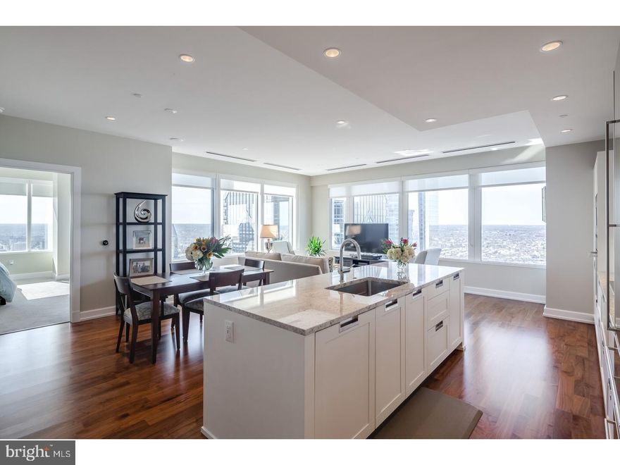 Live in this gorgeous large corner unit where Luxury living has reached new heights in Philadelphia at The Residences at Two Liberty. Five-star amenities and concierge services are yours the minute you arrive. Enter the private resident's lobby with door staff and concierge, at your service 24/7. Elevators with fobbed access provide entrance to your residence as well as the 38th floor amenity level. North and East facing apartment with Spectacular River, City and Sunset unobstructed views in this luxurious corner unit floor plan including 2 Bedrooms plus Den and 2 1/2 baths. The apartment features a contemporary plan with hardwood floors, walls of windows throughout, and an open living room, dining room and kitchen which offers spectacular views of the city. The finishes are of the highest grades including a gourmet kitchen with granite countertops, Snaidero cabinetry and built-in stainless Miele appliances and a Sub-zero refrigerator. Master bedroom suite includes a luxurious marble bath w/ glass enclosed shower and separate tub, dual vanities, and a generous walk-in closet w/ built-in organization. Second bedroom has en- suite bath and additional walk in closet. The den offers an option for a media room, an office or sleeping space, the laundry room has further storage and high efficiency stacked laundry, and a large powder room. With the finest amenities, there is access to a 24hr fitness center/spa with endless pool, steam showers, sauna, yoga studio and massage rooms. There is a business center with board room, media and billiard room, a chauffeured Mercedes town car and room service available from Daniel Stern's outstanding R2L restaurant, with direct resident access. For your convenience, valet parking is available at an additional fee. Liberty Two is in the heart of Center City and surrounded by the best shops and restaurants with access to Rittenhouse Square, Dilworth Park, and the Benjamin Franklin Parkway with world class museums.  Unit has 8 yrs left on partial tax abatement