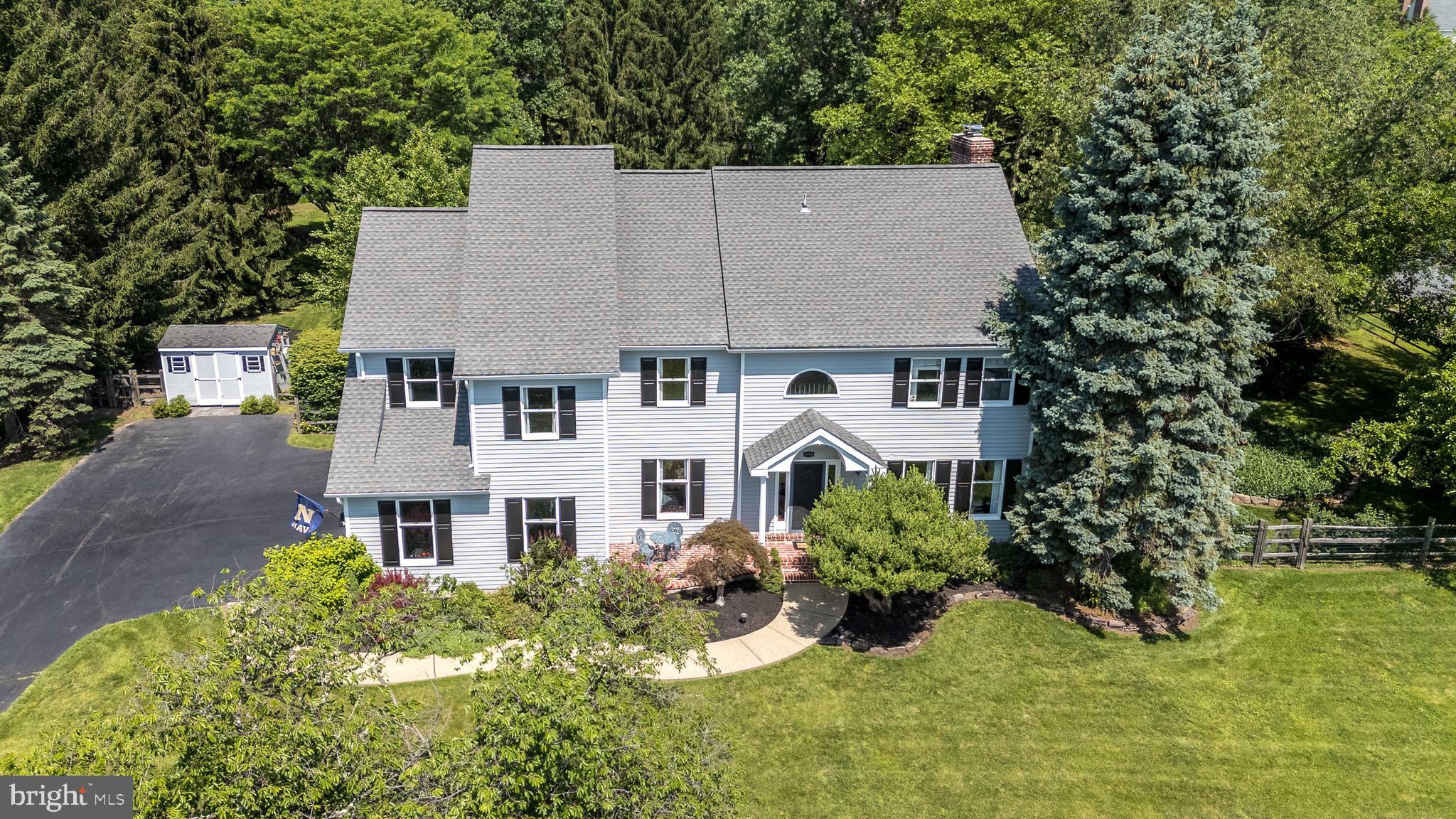 Welcome to 4690 Derby Lane—a beautifully maintained custom-built 4-bedroom, 3-bath home, one of the largest in sought after Fox Hunt Estates, is set on a premium 1.38-acre corner lot with sweeping valley views, in the heart of Bucks County. Thoughtful updates from 2019–2025 blend timeless character with modern comfort throughout. Upon arriving, you'll be greeted by the quaint brick patio as you approach the front door-a great spot for morning coffee. Inside, the two-story foyer opens to gleaming hardwood floors that continue throughout the main floor. The dining room features upgraded moldings, a newer light fixture, and upgraded 4” baseboards. The expansive gourmet kitchen is a chef’s dream with abundance of cabinetry, crown molding, granite counters, a large island with seating, and large walk-in pantry. The sunny breakfast room opens to a covered patio overlooking the private backyard with Sylvan in-ground pool and hot tub. The family room impresses with newer hardwood floors, updated baseboards and shiplap accents, wood ceiling beams, stone fireplace with reclaimed wood mantel and an updated wood-burning insert that heats most of the main floor in cooler months. A widened opening adorned with elegant moldings leads to the living room with crown moldings and plenty of natural light (currently used as a piano room). A full bath and large mudroom, with exterior access to the garage and the pool, complete the main level. Upstairs, the spacious primary suite offers a large walk-in closet updated with hardwood flooring, sitting area, and private library/office, also updated with hardwood flooring. The ensuite primary bath includes a frameless glass shower, whirlpool tub, dual granite vanities, skylight, and entrance to walk-in closet. Three additional bedrooms share a hall bath with updated granite counters, dual sinks, and skylight. Additional highlights include newer carpet, central vacuum, ceiling fans in all bedrooms, and convenient second-floor laundry. The finished basement, updated with luxury vinyl laminate flooring, improved lighting, upgraded moldings, and a 2024 water heater, offers flexible space for media, games, or fitness. Don’t miss a bonus feature of this home, a floored attic space ready for future finishing and is accessible by a wood staircase in the upstairs hallway. Outdoors, enjoy your private pool oasis on a corner lot with a covered patio, Sylvan in-ground pool with hot tub, and plenty of yard to host parties and sports games. Recent exterior updates include additions to the landscaping in the front and back, seven new trees, a fully enclosed wood split rail fence, exterior painting (house and sheds in 2022), a new pool filter in 2024, and new exterior lights at garage doors (6/2025). Located in award winning Central Bucks School District, just minutes to Doylestown Borough’s shops, dining, and cultural attractions as well as easy access to NYC and Philadelphia, this move-in-ready home truly has it all! See full list of improvements available in listing documents. Don't miss this one; reach out to listing agent for a private showing!