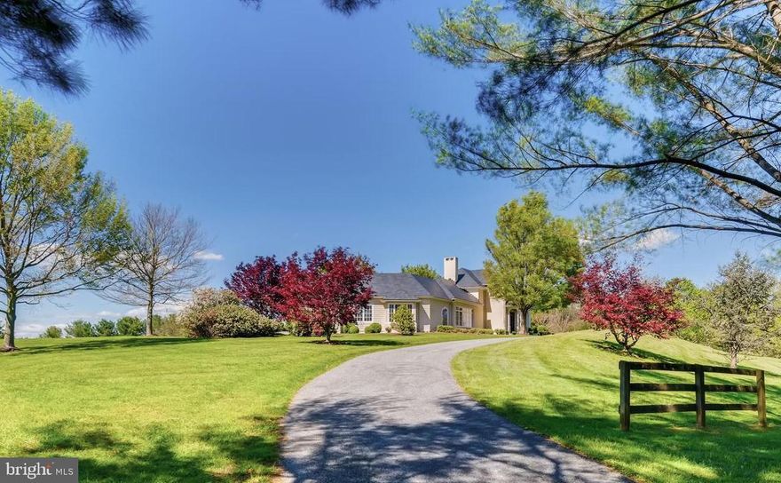 Inspired by English country architecture and situated in the heart of Maryland hunt country this warm and inviting home offers extraordinary panoramic vistas and remarkable pastoral views from every window. The elegant center hall with mahogany door and curved staircase is flanked by understated light-filled formal rooms and sophisticated casual spaces with high ceilings, quarter-sawn random plank oak hardwood flooring, and exquisite millwork throughout. The handsome gourmet kitchen features premium appliances, 6-burner gas range with griddle, expansive island, breakfast room, walk-in pantry, formal butlers pantry, and a mahogany writers desk facing long views of countryside. Highlights of the great room include the soaring cathedral ceiling with exposed beams, built-ins with entertainment center, and a magnificent floor-to-ceiling stacked stone wood burning fireplace extending to covered terrace with outdoor stone fireplace. The spacious main level master bedroom suite opens to second covered blue stone terrace for quiet respite. A finished basement offers second family room with wood burning fireplace, game room, fitness room, and full bath. Country-sized mud room for pets and lacrosse sticks. 8-stall stable includes office and dressage barn. Perennial gardens and gently manicured rolling lawn merge into pastureland and woodlands with riding trails providing diverse habitats for a multitude of native plants and animals. Nature abounds - witness bald eagles, red-tailed hawks, kingfishers, blue herons in flight. Enjoy the cacophony of peepers in near-by ponds on warm summer evenings, and seasons defined by wildlife who make the valley their home. Outdoor enthusiasts are drawn to the area known for steeplechase and equestrian events, horseback riding, biking, hiking, hunting, sporting clays and fly-fishing. Neighbors are committed to conservation and take pride in protecting open space and the rural and agricultural character of this renowned region. A unique and breathtaking property in a coveted and private location.