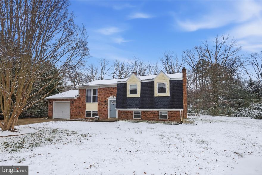 This updated 4 bedroom, 3 bathroom split foyer is centrally located in St. Mary's County, with multiple large common areas and a large, level yard. The house is just 10 minutes from NAS PAX Gate 1, Chancellor's Run Park, restaurants, shopping, coffee shops, and grocery stores, and the number of finished spaces offer great flexibility for a variety of living arrangements. A major remodel was completed in 2020, including a new roof, new water heater, and new HVAC unit.

The upper level of the home features a large living space, a kitchen with extended peninsula countertop, and two large sliding glass doors to the rear deck, bringing in natural light from the front and rear of the house. The large back deck overlooks the grassy, level rear yard, offering great opportunities for entertaining and hosting in pleasant weather. The whole upper level features updated wood flooring. The kitchen features stainless steel appliances, stone countertops, and a combination of recessed lighting and pendant lights.

The hall bathroom has been updated with ceramic tile and clean finishes for the vanity, mirror, and fixtures. There are two smaller bedrooms and a larger primary bedroom with attached bathroom. The attached bathroom has been updated as well, and features a tiled shower with glass doors. 

Downstairs, there is a large fourth bedroom, another full bathroom, a laundry room with updated ceramic tile floors, and a large rec room with fireplace and LVP flooring. The lower level offers direct access to the attached garage, and there is a rear door from the garage to the back yard. The garage can accommodate a mid-size vehicle, and there are storage shelves and a small workshop area as well.