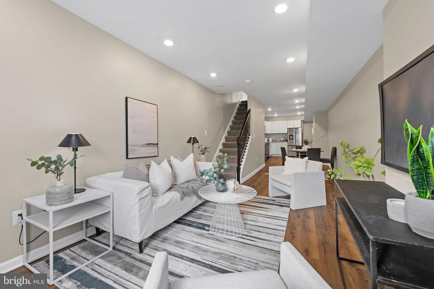 This home is eligible for the MMCT program, this program will allow for zero down financing and qualified buyers can get a grant up to $5000. Welcome home to 1148 Carroll St perfectly located in the heart of Pigtown! This turn-key 4 Bedroom 4 Bath home boasts all the upgraded finishes you can ask for! Step inside and you’re greeted with an open floor plan renovated top to bottom. The spacious living room leads into the beautifully updated modern kitchen featuring upgraded counters, new cabinets and stainless-steel appliances and gorgeous LVP flooring throughout the entire home. Off the kitchen is a main level bedroom and full bath and a back door leading to the fenced backyard and patio perfect for entertaining. The main level bedroom can also be rented out as it has its own private separate entrance to the home.  All bathrooms have been updated with beautiful modern finishes. On the second floor, you'll find bedrooms 2 & 3 and 2 more fully updated full bathrooms.  On the 3rd floor, you will find the primary bedroom with a gorgeous en-suite bathroom featuring elegant Encaustic Amantus Porcelain tile floors and a double sink vanity. There are great views of the skyline from the 3 large windows in the bedroom. Your laundry area with a stacked washer/dryer is conveniently located upstairs as well. Plenty of storage space is available on the lower level of the home. Prime location, a short walk to M&T Bank Stadium and Camden Yards perfect for game day. A quick drive to Baltimore's inner harbor with shops and restaurants! Convenient commuter routes to 95, 695, 295, and 83