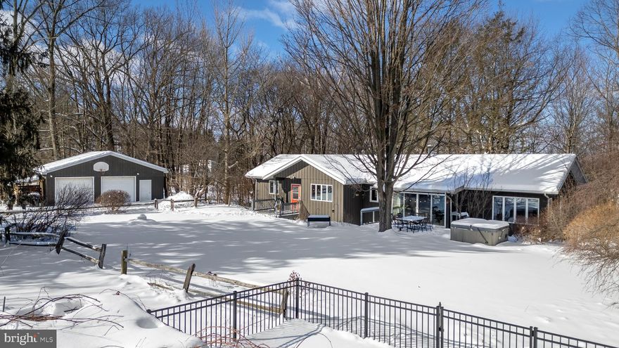 Nestled in nature, this contemporary ranch offers expansive outdoor space and a peaceful,
private setting. Inside, a spacious tiled foyer greets you with a mid-century modern flair,
setting the tone for the home’s thoughtful and inviting design. The open living room is
centered around a fireplace and framed by expansive windows that overlook the valley,
with direct access to the upper deck—perfect for relaxing or entertaining. From here, the
home flows seamlessly into a study with built-in shelving and the dining room which offers
access to the front deck. The adjacent kitchen features porcelain tile countertops, a
breakfast island bar and an efficient layout ideal for everyday living. The primary bedroom
is complete with a spacious en suite bathroom featuring a double vanity and a relaxing
jetted tub. The main level also includes two additional bedrooms and a full bathroom with
laundry.  The lower level offers exceptional versatility enhanced by a separate entry that
makes it ideal for guests or multi-generational living.  Enjoy an additional living area
centered around a propane stove with a nearby kitchenette complete with an additional
washer and dryer. The spacious fourth bedroom is also located on this level along with two
additional bonus rooms that offer endless possibilities for your needs. The property’s
expansive nine and a half acres offer plenty to enjoy outdoors! Relax in the in-ground
fenced pool or unwind in the hot tub on the deck. Additionally, the property features
established gardens, a chicken coop, solar panels, and a detached two-car garage. You’ll
fall in love with this well-loved 1970 home, beautifully designed by architect James Cartey.