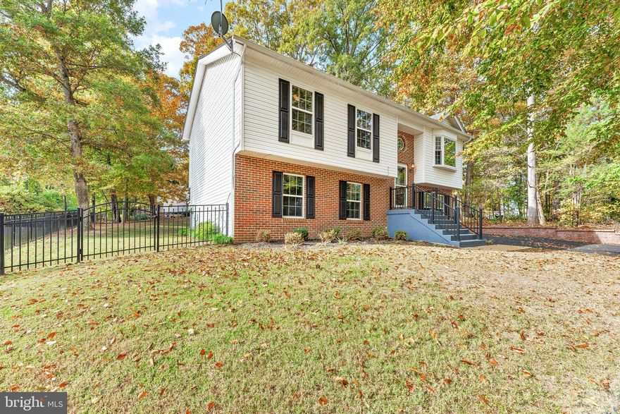 IMMACULATE HOME on a GREAT LOT with LAKE VIEWS!!! Split foyer with over 2000 sqft, 4 bedrooms, 2.5 baths, and a wonderful location. The recently seal coated paved driveway and fresh landscaping show pride of ownership as soon as you pull up. Heading inside you are greeted by an open concept foyer with solid oak stairs/railings. Upstairs the family room and hallway have  beautiful tigerwood flooring. The updated kitchen includes stainless appliances, ceramic tile, and recently installed granite countertops. Just off the dining area is the homes brand new 18x22 oversized deck that overlooks the flat fenced in back yard. From the back yard you can see lake lariat across the street from almost any location. Heading back inside and down the hall you will find the homes primary bedroom/bathroom, bedrooms 2 and 3, as well as the hall bathroom. Both bathrooms are updated nicely and the bedrooms are sizeable with new carpeting. Downstairs the large rec room is perfect for gatherings. A wet bar and a half bathroom are located just off of this area. Completing the lower level are the home's 4th bedroom and a large finished laundry/storage room. The walkout slider off of the rec room provides easy access to the wonderful fenced back yard.  New architectural roof was installed 1 year ago. This location is one to be desired and this home is ready for your pickiest buyers. DO NOT WAIT or you may miss this wonderful OPPORTUNITY!