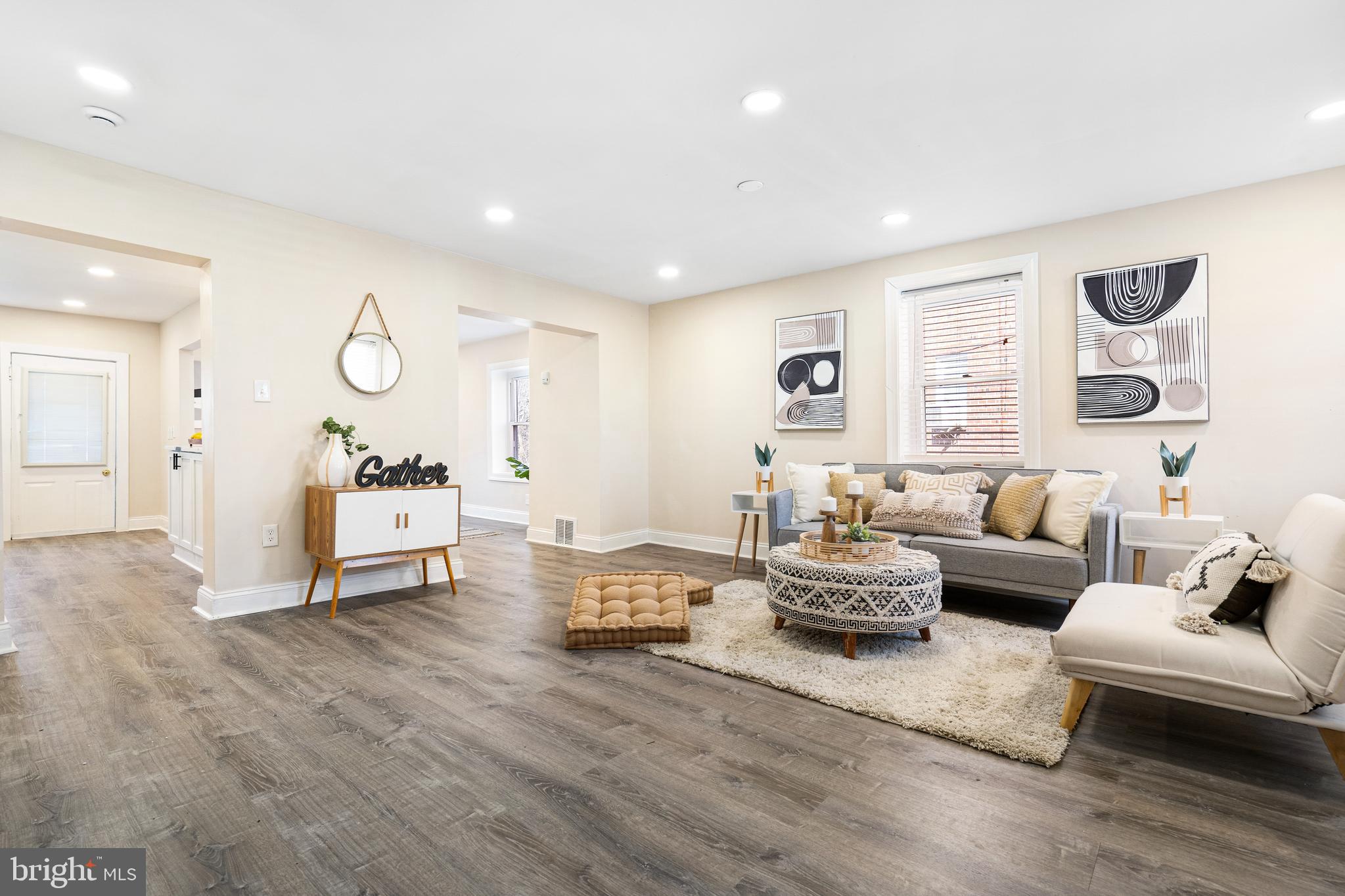 Seller is offering a 2% Seller Credit with a full price offer by April 17, 2025! Take advantage of $0 down payment home loan options and make homeownership more accessible than ever! Welcome to this beautifully remodeled brick-front end-of-group rowhome, offering modern upgrades and a functional layout. Start your mornings with a cup of coffee on the covered front porch while watching the sunrise. Inside, you're greeted by luxury vinyl plank flooring throughout, creating a seamless and stylish flow. The spacious living room is perfect for entertaining, while the open dining area provides the ideal space to wine and dine guests. The renovated kitchen features quartz countertops with black accents, a sleek tile backsplash, stainless steel appliances, and ample cabinetry, offering both style and functionality. Upstairs, you'll find three comfortable bedrooms and a full bathroom with a tile surround tub/shower combo. The finished lower level offers versatile living space, perfect for a rec room, additional living area, or home office, and also includes a newly installed full bathroom. Step outside to the deck and fully fenced yard, perfect for entertaining guests and hosting summer BBQs. Recent Updates (2024): Roof, Electrical Panel, Water Heater, HVAC System. Conveniently located near Reisterstown Road, Liberty Heights Ave, Mondawmin Mall, and Druid Hill Park, this home offers easy access to shopping, dining, and outdoor recreation. Schedule your showing today!