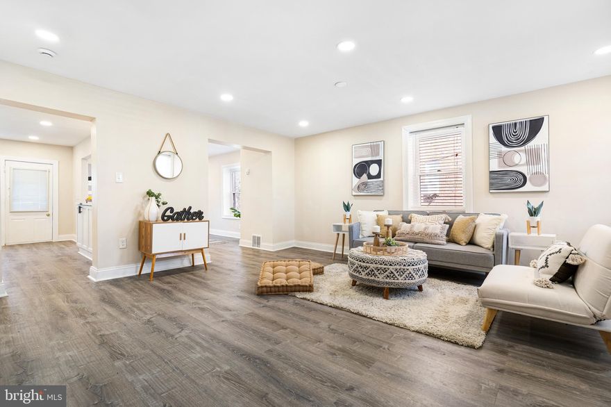 Seller is offering a 2% Seller Credit with a full price offer by April 17, 2025! Take advantage of $0 down payment home loan options and make homeownership more accessible than ever! Welcome to this beautifully remodeled brick-front end-of-group rowhome, offering modern upgrades and a functional layout. Start your mornings with a cup of coffee on the covered front porch while watching the sunrise. Inside, you're greeted by luxury vinyl plank flooring throughout, creating a seamless and stylish flow. The spacious living room is perfect for entertaining, while the open dining area provides the ideal space to wine and dine guests. The renovated kitchen features quartz countertops with black accents, a sleek tile backsplash, stainless steel appliances, and ample cabinetry, offering both style and functionality. Upstairs, you'll find three comfortable bedrooms and a full bathroom with a tile surround tub/shower combo. The finished lower level offers versatile living space, perfect for a rec room, additional living area, or home office, and also includes a newly installed full bathroom. Step outside to the deck and fully fenced yard, perfect for entertaining guests and hosting summer BBQs. Recent Updates (2024): Roof, Electrical Panel, Water Heater, HVAC System. Conveniently located near Reisterstown Road, Liberty Heights Ave, Mondawmin Mall, and Druid Hill Park, this home offers easy access to shopping, dining, and outdoor recreation. Schedule your showing today!