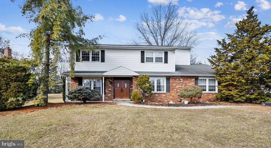 Welcome to this spacious center hall colonial home situated in a gorgeous neighborhood on an almost ½-acre flat lot.  With 3800 sq feet of living space, an in-law suite, home office and large primary suite, this home has much to offer. A covered porch with double door entrance greets you as you arrive bringing you into the foyer with a convenient coat closet and powder room. On either side of the foyer, you will find a bright living room/play room and a large dining room that can accommodate an oversized dining table. The eat in kitchen offers plenty of cabinet and counter space and looks out over the beautiful backyard. New flooring in the dining room, kitchen, and mudroom. Fresh paint throughout most of the house. The family room with a wood burning fireplace offers a cozy place to relax and has a perfect bump out for a possible projector. The side entrance offers access to a convenient oversized mudroom and the in-law suite. The in-law suite (or possible au pair suite) has bamboo flooring, a walk-in closet, and an updated handicapped accessible bathroom with heated natural stone flooring. Upstairs the oversized master bedroom suite offers more than enough space for a king size bed, an office or sitting space, a has a terrific ensuite updated bathroom with an oversized ceramic tiled shower with a rainfall shower head and a classic shower head, privacy commode, double sinks with granite vanity tops and 2 large walk-in closets with professionally installed closet organizer systems. Three other large bedrooms with ample closet space, an upstairs good sized laundry room with newer large capacity washer/dryer and utility sink, and a hall bathroom with a Swanstone tub and vanity top complete this level. The upstairs front bedroom is super quiet and makes for a great office. Full unfinished basement offers amazing storage space and play area for kids. 3 large closets, a huge attic, the basement and shed will take care of all your storage needs.  A brick patio and a beautiful flat back yard with a 2-year old professionally installed superior play system are just perfect for your outdoor enjoyment and entertaining. Spring foliage creates great privacy along the backyard and side perimeter of the lot. Covered side patio is great for kid’s sports gear. Conveniently located with easy access to 309 and just minutes from Colmar train station, walking trails, a creek, green space, ice hockey and ice skating. Motivated seller able to accommodate a quick close.