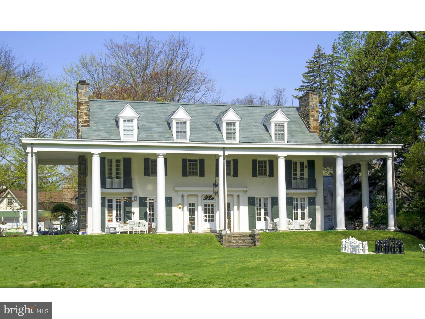 Southern Colonial...on the Main Line! You will be proud to be the owner of this picturesque residence that combines the charm of a bygone era with today's conveniences...yet not detracting from the elegance of the original design. Soaring columns support the portico of this southern-inspired stately home. The flexible floorplan boasts high ceilings, crown moldings, 4 fireplaces, solarium, study, office, 4 spacious bedrooms plus a guest suite. The gated entrance welcomes you to a flat acre which is totally fenced & offers professionally landscaped grounds, a spacious rear deck, rear patio, 2 car garage, charming storage/playhouse, large stamped concrete patio...plus too many features to list. This one of a kind property must be seen. Most conveniently located on a beautiful street, in a beautiful Lower Merion neighborhood. Total privacy & yet just minutes to Center City Philadelphia & all major roadways.