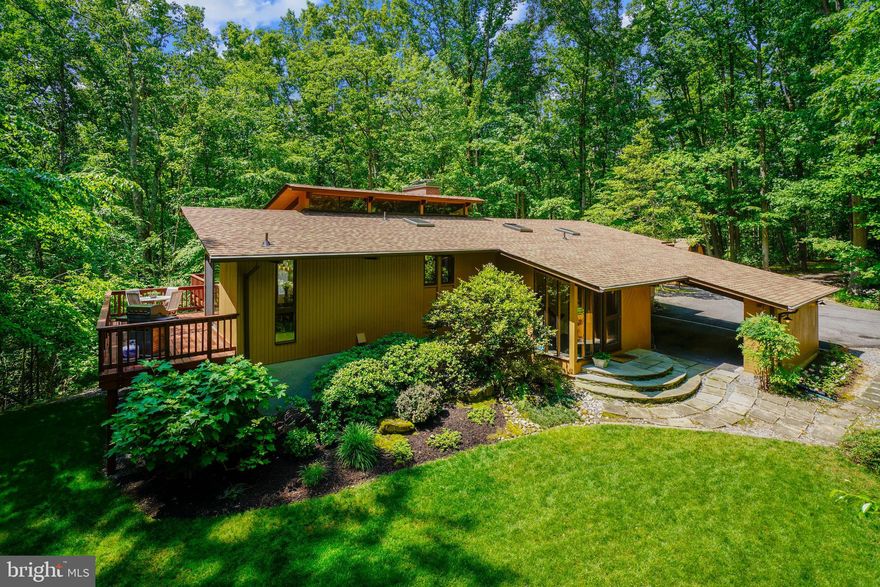 Move right into this tastefully updated and beautifully maintained 3 BD, 3 BA , 2693 finished square foot deck house on a very pretty and private 1 acre lot.  Walls of windows, breathtaking views, vaulted wood ceilings, gorgeous hardwood flooring and wrap around decking are just a couple of the features you will love.  Renovated kitchen with soapstone counters, tile backsplash, stainless steel appliances to include double wall ovens, induction cooktop with hood, Bosch dishwasher, refrigerator and second beverage refrigerator open to dining and living room and decks make this home PERFECT for entertaining.    Relax in your spacious owner's suite complete with 2 closets, private balcony and updated bathroom with oversized shower,  neutral tile dual vanities.  Two additional bedrooms, currently used as offices, are also on this main floor.  Lower level consists of exercise room , family room with built ins and slider to patio, workshop, full bathroom and storage.   Carport will accomodate 2 cars and asphalt driveway with various parking pads provide plenty of space for an RV, boat and additional cars.  Community pier and kayak rack are a short walk away.  Minutes to 214 with easy access to Route 50 and DC and a short ride to Annapolis.  Home has been well maintained and shows well.   Home is being sold as is.   Welcome to your new home.  Welcome to 3175 Rolling Road!