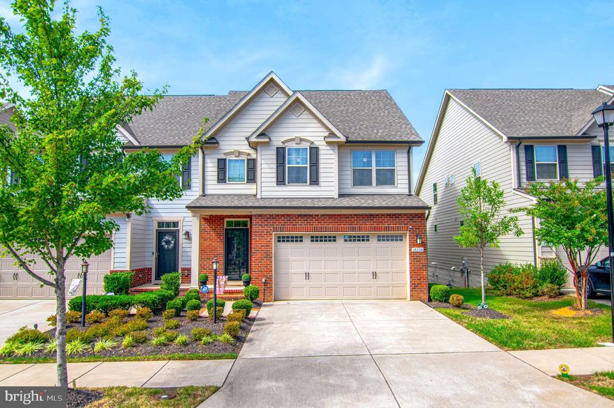 Why wait for new construction when you can move right into this impeccably finished home with every upgrade already in place? From the moment you step into the dramatic two-story foyer, you’re greeted by wrought-iron railings, soaring 10-foot ceilings, and elegant crown molding throughout.  The sun-filled main level offers an open layout designed for both everyday living and effortless entertaining. A chef’s delight, the gourmet kitchen features granite countertops, stainless steel appliances, and a pantry, and seamless connection to the generous dining area and inviting living room. Step outside to a spacious Trex deck with an awning and solar lighting, where a peaceful, tree-lined backdrop creates a private retreat for morning coffee, weekend barbecues, or quiet evenings. The main-level primary suite is a luxurious escape, complete with a spa-inspired bath showcasing a dual-sink granite vanity, a walk-in ceramic-tile shower, and an expansive walk-in closet. Upstairs, you’ll find three sizable bedrooms (two with walk-in closets), a full bath with double granite vanity, and a versatile loft—perfect for a home office, play area, or lounge. The walkout lower level adds over 1,200 square feet of finished living space, ideal for entertaining. Enjoy a full bar with granite countertops, icemaker, and mini-fridge, a large recreation room with a built-in entertainment center with multicolor accent lighting, a full bath, plus a bonus room for an office or fifth bedroom (NTC), along with ample storage. Residents of Potomac Shores enjoy premier amenities including the Jack Nicklaus Signature Golf Course, Tidewater Grill, multiple pools, scenic walking and biking trails, a community garden, greenhouse, and much more. Commuters will love the easy access to I-95 and Route 1, with Fort Belvoir and Quantico nearby. A new VRE station is anticipated in 2026 and a new elementary school in 2027.  This home truly has it all—schedule your visit today!