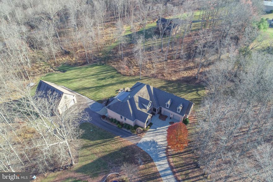 Discover the ultimate mountain–lake getaway in this stunning 5BR Southern-style home on a private 2.4-acre wooded lot bordering Broadford Lake recreational area! Located just minutes from Deep Creek Lake and Wisp Resort, this magnificent property offers over 6,500 sq ft. and delivers unforgettable space, luxury, and privacy. Step inside to soaring cathedral ceilings, skylights, oak floors, and a gourmet kitchen featuring solid cherry cabinets cut from trees on the property, granite counters, and a center island built for gathering. The main-level primary suite feels like a retreat, complete with a cozy fireplace, walk-in closets, and a spa-worthy bath with custom tilework and an oversized shower. The fully finished walkout lower level is an entertainer’s dream—with a full second kitchen, bar, wine room, gym, gas fireplace, and French doors that open to the patio and backyard. Outdoors, enjoy a massive deck, screened porch, two patios, a bubbling hot tub, and a firepit perfect for starry nights. Car enthusiasts, boaters, and adventurers will love the attached 2-car garage PLUS a 28x48 detached garage with utilities and a huge upper level ready to finish. Direct access to trails, a beach, playground, and fishing pier makes every day feel like vacation. This is the lifestyle you’ve been waiting for!