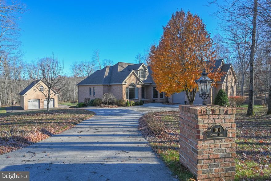 Discover the ultimate mountain–lake getaway in this stunning 5BR Southern-style home on a private 2.4-acre wooded lot bordering Broadford Lake recreational area! Located just minutes from Deep Creek Lake and Wisp Resort, this magnificent property offers over 6,500 sq ft. and delivers unforgettable space, luxury, and privacy. Step inside to soaring cathedral ceilings, skylights, oak floors, and a gourmet kitchen featuring solid cherry cabinets cut from trees on the property, granite counters, and a center island built for gathering. The main-level primary suite feels like a retreat, complete with a cozy fireplace, walk-in closets, and a spa-worthy bath with custom tilework and an oversized shower. The fully finished walkout lower level is an entertainer’s dream—with a full second kitchen, bar, wine room, gym, gas fireplace, and French doors that open to the patio and backyard. Outdoors, enjoy a massive deck, screened porch, two patios, a bubbling hot tub, and a firepit perfect for starry nights. Car enthusiasts, boaters, and adventurers will love the attached 2-car garage PLUS a 28x48 detached garage with utilities and a huge upper level ready to finish. Direct access to trails, a beach, playground, and fishing pier makes every day feel like vacation. This is the lifestyle you’ve been waiting for!