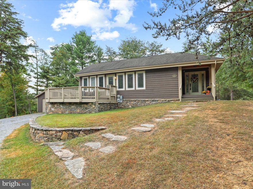 Experience serene one-level living at 26 Pathfinder Lane in The Woods Resort. This beautifully updated rancher offers stunning views of the golf course and mountains, with two expansive decks perfect for enjoying the abundant wildlife. The primary suite features a luxurious dual-headed shower and opens directly to the back deck, while two gas fireplaces and a detached two-car garage add to the home's comfort and convenience. With granite countertops, new flooring, and all on one level, this home is the perfect blend of nature and modern living. Schedule your private tour today.