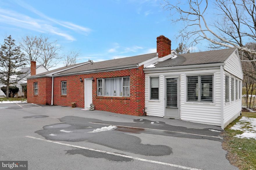 Residential, Business, Investment...The choice is yours!   Currently used as a rental, but was previously used as a business.  Fronts US 522, with a parking lot in front of home, with a walk out basement, leading to a back and side yard.    4 BR, 1 BA on the main level plus a sun room for added seasonal use.  Featuring a spacious LR with WB Fireplace, Kitchen/Dining combo.  Kitchen and Bathroom have laminate flooring and remaining main level has hardwood floors.  Basement is mostly finished with with drywall.  Painted concrete floors.  Add carpet or other flooring for a more finished look.  Combo 1/2 bath and Laundry, also with painted contrete floor.   Unfinished mechanical room.