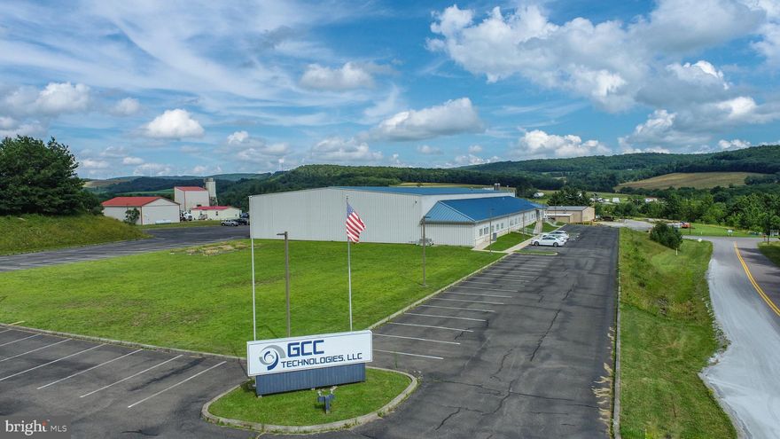 Secured 30,000 sq ft compound zoned commercial, just off State Route 135. Currently configured with 13 offices, 3 conference rooms, 2 open bullpens, a formal lobby and much more. Full kitchen and dual restrooms support all-day operations. Rear flex bay runs 100 x 120 with twin full-height doors, ideal for storage, shipping, or clean tech. Climate-controlled server space and a whole-site generator in place. Paved lot, easy access, plenty of parking. Call today for details!