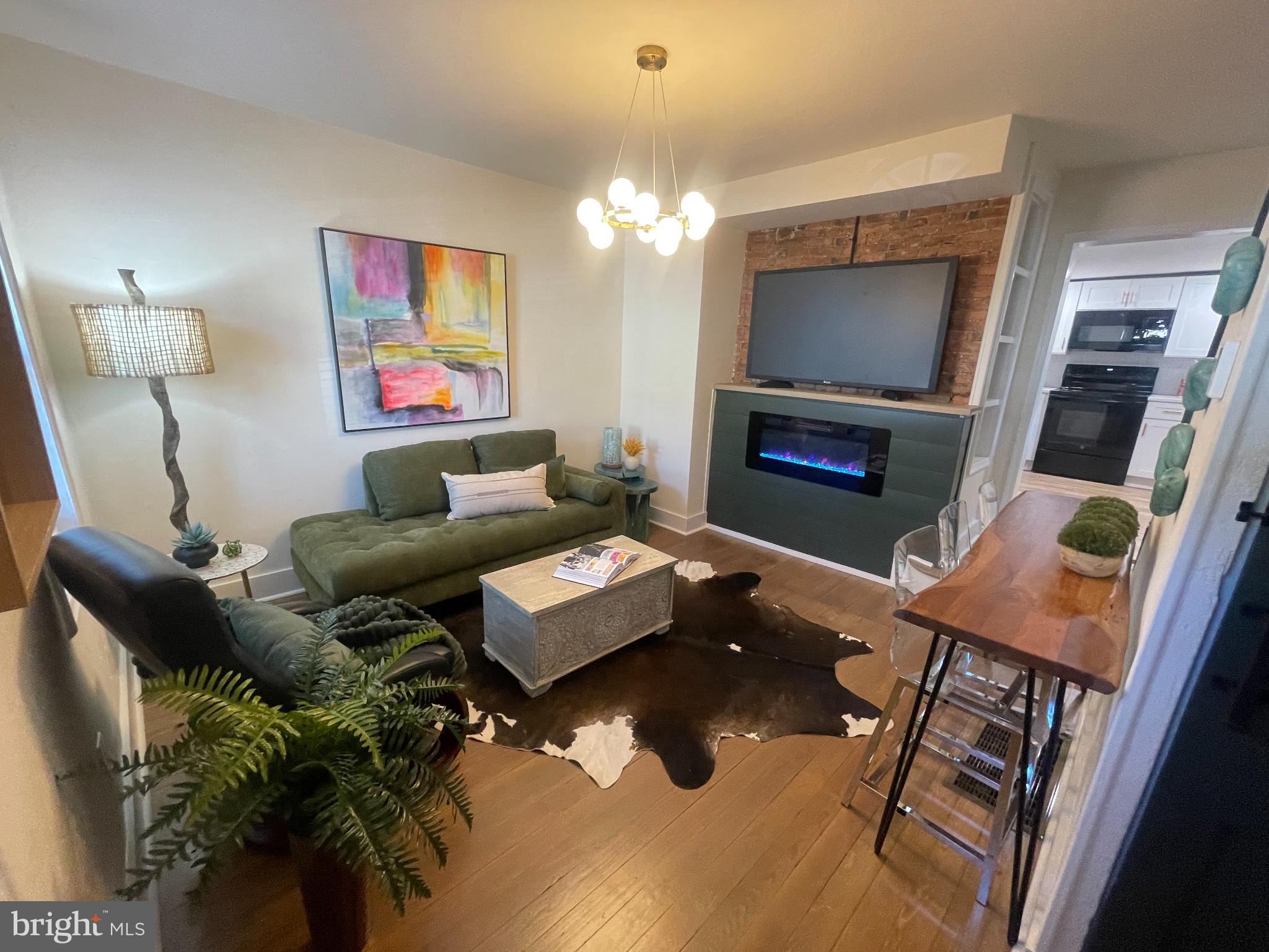 Welcome to this beautifully updated end-of-row home, complete with a picture-perfect white picket fenced yard. Originally built in 1890 and fully renovated in 2025, this charming residence offers the perfect blend of historic character and modern convenience.
Inside, you'll find 816 square feet of intelligently designed living space—cozy, stylish, and incredibly functional. The inviting covered front porch is ideal for relaxing summer evenings. Step into the warm and welcoming living area, featuring exposed brick, refinished hardwood floors, and a cozy fireplace that anchors the space.
The open-concept living and dining area flows effortlessly into the brand-new white kitchen, outfitted with quartz countertops, a sleek tile backsplash, and all-new appliances—perfect for entertaining or enjoying everyday living.
This home offers two beautifully appointed full bathrooms, including a luxurious first-floor walk-in shower. A convenient first-floor bedroom and laundry area make for easy single-level living if desired.
Flooded with natural light and full of charm, this home is a rare find. Don’t miss your chance to own this nugget-sized treasure—