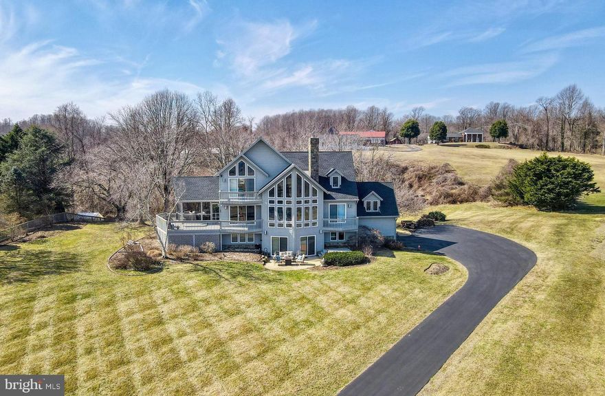 Welcome to 6912 Konrad Court! Perched atop a hill in the tranquil Chesapeake Overlook community, this exceptional 5-bedroom, 3-bath contemporary home boasts breathtaking views of the Chesapeake Bay from every level.

As you step inside, you'll immediately be captivated by the panoramic bay views through a stunning wall of windows in the great room. The heart of the home, the great room features a two-story wood-burning fireplace, offering ample space for both relaxation and entertaining. The room flows seamlessly into the formal dining area (with deck access) and a well-appointed kitchen --complete with granite countertops and newer stainless steel appliances. Just off the kitchen, pocket doors lead to a versatile laundry room/office/butler’s pantry. The expansive screened-in porch, with its high ceiling, provides additional space for outdoor dining and entertaining, with easy access to the deck and yard.

On the north side of the main level, you’ll find a full bath and two additional bedrooms, one of which has deck access, along with yet another stunning view of the bay.

The upper level offers a bright and spacious primary suite, complete with a private deck, a large ensuite bath, walk-in closet, and cathedral ceilings. The room is bathed in natural light from two-story windows that frame the spectacular bay views. A walkway leads past the two-story family room to a second bedroom or office on this level, featuring dual closets and expansive views of the bay towards the bridge.

The fully finished lower level is perfect for extended family or guests, offering a cozy family room with a fireplace and built-in bookshelves, a full kitchen with bar seating, a bedroom, and a full bath. It also includes access to the two-car garage and walk-out access to a front yard patio and hot tub. With bay views from both the living area and bedroom, this level is ideal as a private in-law or au pair suite, or simply as additional entertaining space.

Additional features of this home include a whole-home generator, radon mitigation system, central vacuum system (as-is), underground sprinkler system, beautiful landscaping, and abundant storage. Recent updates within the past five years include new siding, and a new roof.  Minutes from Herrington Harbour South Marina and the charming town of North Beach. Only 45 min to DC, Old Town Alexandria and DT Annapolis.  Beach and bay access from community rec area!

This truly one-of-a-kind home is waiting for you!