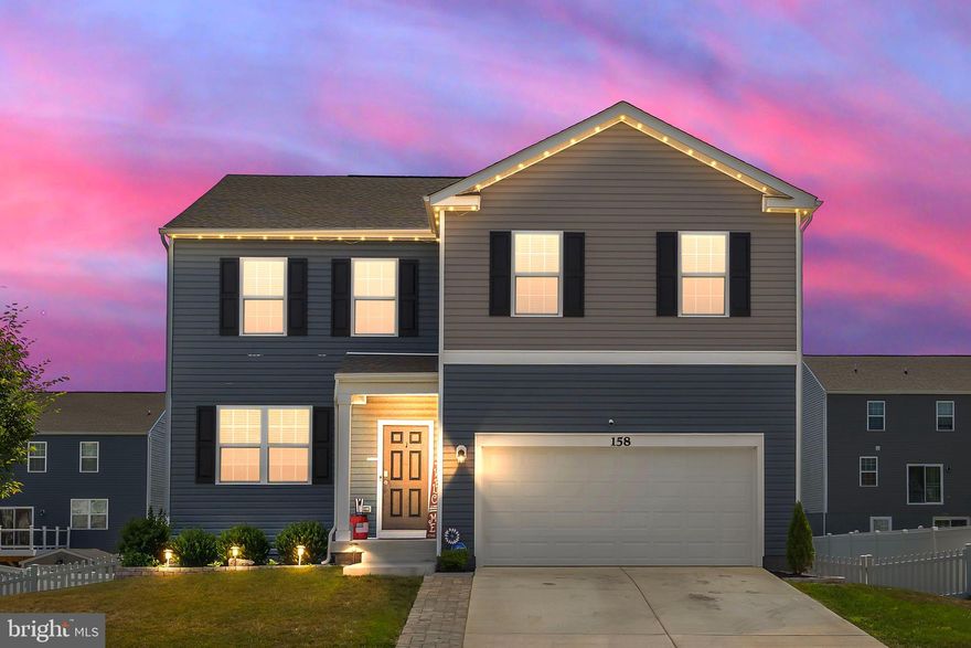 Better than new—and ready for you! First-time homebuyers may qualify for up to $5250 in grant funds. Built just 2 years ago, this beautifully maintained Galen model blends the convenience of new construction with thoughtful personal touches you won’t find in a builder-basic home.  Yes, the annoying little details builders don't add: the towel rods, ceiling fans, quality, colorful paint, & blinds have all been done for you! Plus, be the talk of the neighborhood every holiday with your customizable outdoor uplighting  LED lighting all changed from an app. Step inside to an open-concept main level with fresh paint and upgraded carpentry details throughout. The living area centers around an electric fireplace with a custom mantel & hidden storage—a clever, stylish upgrade you’ll love. The partially finished basement offers a walk-out slider to the owner added patio, plus room to finish a 5th bedroom and a rough-in for an additional full bath. In the unfinished utility area, added shelving keeps everything organized, plus water softener & sump pump included. Out back, enjoy a fully fenced yard with low-maintenance vinyl fencing—ideal for pets, play, and privacy. The garage is more than just parking space, with epoxy-painted floors, a wall-mounted TV,  a wall-mounted air compressor, & heater for your projects year round. Enjoy a relaxing laundry room on the bedroom level, a primary suite with all the natural sunlight & large walk in shower, & a room for everyone. All electric utilities and low HOA dues, this is a deal! Located in an ideal commuter location for Northern Virginia and Maryland, yet minutes from the charming shops, dining, and history of downtown Charles Town. Here, you can have the best of both worlds—modern convenience and small-town charm.