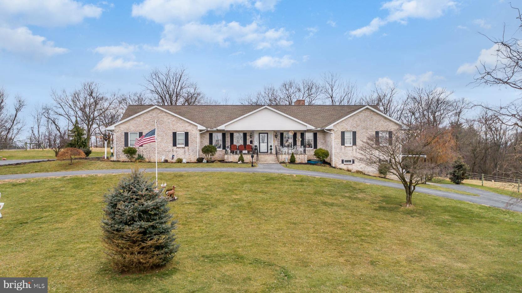 They don't build them like this anymore! This is a SOLID all brick home. The circular driveway with a grass island center could host a large amount of cars, horse trailers, etc. This 6 Ac farmette has so many possibilities. All around this home you can admire a beautiful view; from the pasture to the mountains and all of the large homesites in between. Let's start with the outdoor 50'x60' pole building with 13'high ceilings. There are 4 stalls each with their own garage door that allows each access to the pasture. Each stall has water heater. The house has an oversized 2 car garage with a stair case leading up to a FULL attic that spans the length of the 3000 square foot above grade home. This has finishing possibilities if one desired. From this garage, you enter into the end of the home that has the 4th bedroom or office. Also on this end of the home is a laundry room which doubles as a full bath. Closets are in complete abundance throughout this home as they are everywhere! The formal dining room of 14'x16'.8 is larger than average and has a beautiful Italian Chandelier. Step from the covered front porch into the main entrance large enough to have a gathering. The formal living room is off of the foyer. The kitchen has an island, double oven, lots of cabinet space and an adjacent informal dining space. Leading towards the bedrooms is a family room with an entire wall of brick and a wood burning fireplace in the center. The sliding doors in this room lead to a large covered rear patio. The 1st of four upstairs bedrooms has a decorative brick fireplace. The 19' x 14' master bedroom has an entrance to the upper level balcony with views. This offers an area to enjoy the everyday views of the valley and 4th of July fireworks. The upstairs of the home has in total 4 Bedrooms and 3 full baths. The lower level could be an entertainer's dream or a perfect Au Pair or parent apartment. The end of the basement offers an integral garage that is oversized at 24'x24' and a double sliding door. The basement has a secret safe room that viewers will not find. There is a potential 5th bedroom and a full bath down here, but the main attraction is the HUGE amount of entertaining space. There is a second full brick wall with a wood-burning fireplace a wet bar and another large storage room. The lower level makes the total finished space near 6000 sq ft. Most all mechanicals of the home have been replaced. The house is utilizing a heat pump currently, but there is also an Oil furnace AND an additional furnace that doubles for coal or wood. This home must be seen to be appreciated. The space and the natural lighting throughout this home make it most desirable. Updating most would do but conditionally this home is move in ready.