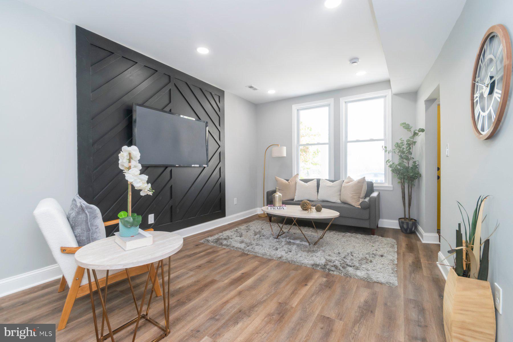 Welcome to 2754 Ellicott Driveway—a charming brick townhome that blends classic Baltimore architecture with modern flair. Step into a sunlit living room featuring a bold accent wall that adds personality and warmth. The updated kitchen flows seamlessly into the dining area, perfect for entertaining. Out back, enjoy the convenience of a private parking pad, a rare find in the city. With spacious bedrooms and a finished basement, this home is move-in ready and full of character.