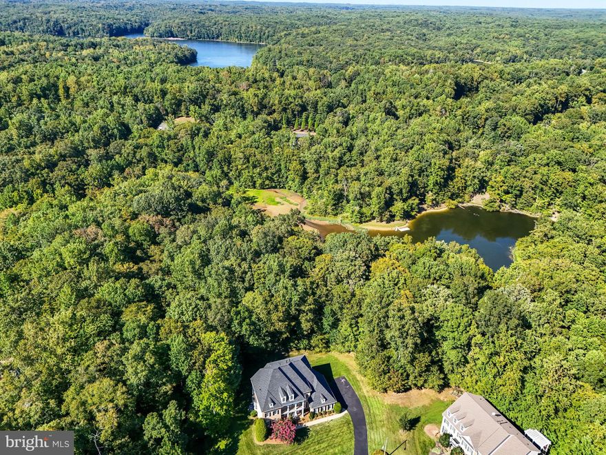 Just reduced 50,000! This exquisite residence is situated in River Falls on the Occoquan, Prince William's distinguished golf course community, home to the renowned Old Hickory Golf Course. The property boasts a picturesque backdrop, as it backs onto the Occoquan Reservoir, providing easy access to nature with a backyard perfect for launching your canoe or kayak or simply enjoying the tranquility and wildlife.
Featuring the open floor plan of the Davenport home model by Basheer & Edgemoore, this residence is a masterpiece. A spacious TREX deck offers stunning views of the secluded acreage. With four fireplaces, the home exudes warmth and charm. The basement is an entertainer's delight, complete with a full bar, a large recreation room, a separate game room, a media room, an additional bedroom with a full bath, and ample storage space.

The property's roof and HVAC units are less than 5 years old, and the yard is equipped with a sprinkler system with fertilizer application. Enjoy the convenience of surround sound on multiple levels of the home. Boasting five generous bedrooms and 5.5 bathrooms, each with walk-in closets, this residence is designed for comfort and luxury. The primary suite is particularly noteworthy, featuring expansive walk-in closets and a luxurious Jacuzzi tub.

Don't miss the opportunity to reside in Prince William County's premier golf course community, with top-rated schools including Colgan High School, Benton, and Westridge. This home, resembling a model home in its immaculate condition, is a rare find – seize the chance to make it yours.