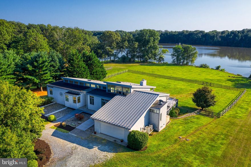 Outstanding architect-designed modern home nicely positioned on the water in the highly regarded Fairgale Farm Estates.  The interior floor plan with very high ceilings, floor to ceiling windows and multiple decks overlooking a sweeping lawn to Fairlee Creek is reminiscent of a home in the Hamptons (without the traffic and price tag).  The main level begins with a generous foyer, coat closet and powder room. The large two-story great room with fireplace welcomes all who enter. At both ends of the house are lovely bedrooms with private baths and closets. A gallery like hallway runs the length of the home with a handsomely designed galley-like kitchen with seated counter space,  glass enclosed den/office, intimate dining room, and two staircases to the lower level. The lower level with nine foot ceilings and picture perfect views of the lawn and water boasts three bedrooms, three baths, a family room and amazing amounts of storage space. A bonus solarium room is accessed from one of the many patios.  The community dock offers a private boat slip and scenic hiking paths. A unique offering in Kent County.