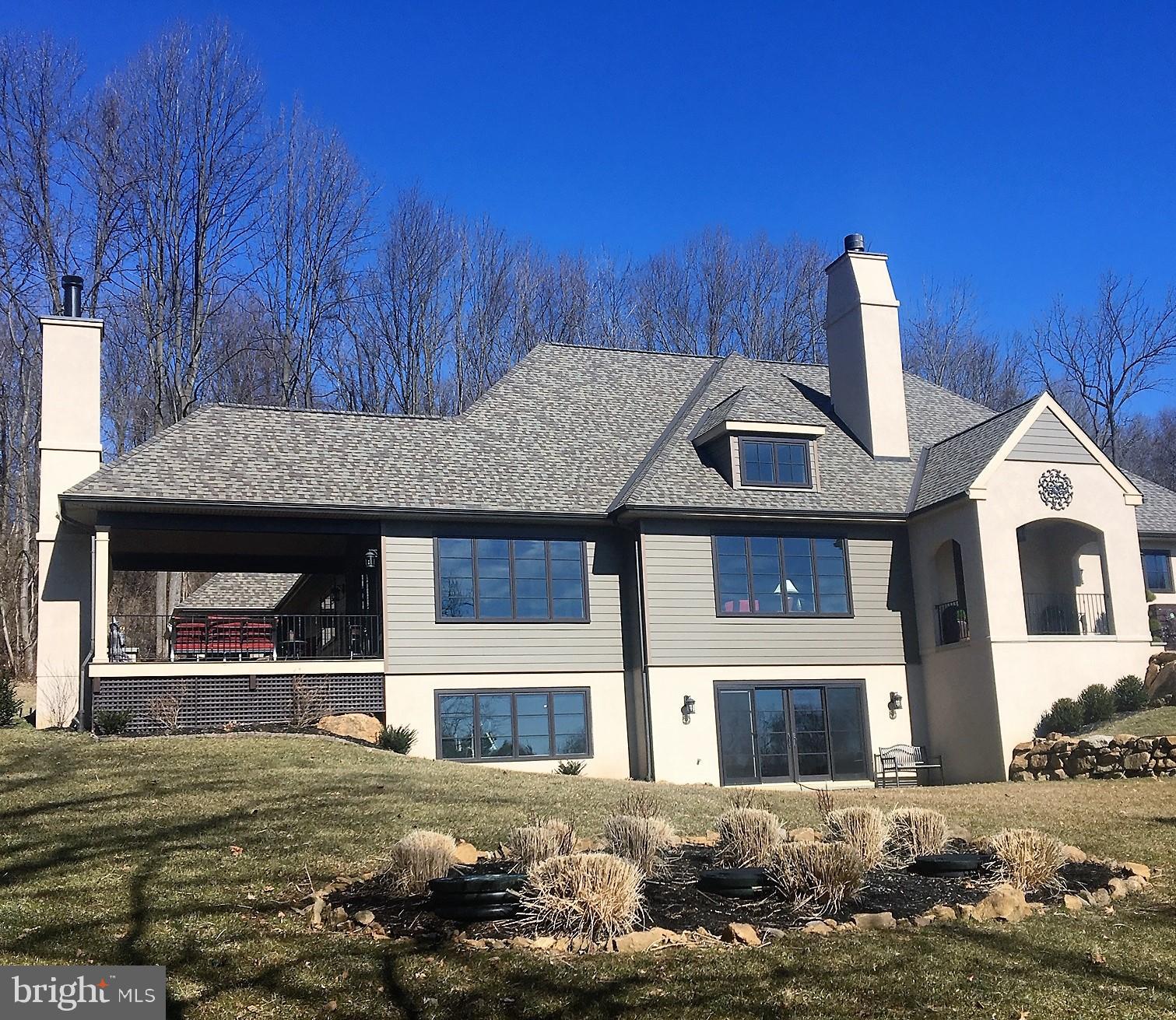 Custom John Diament built gem only 2-1/2 years ago with coveted 1st floor Master Suite. Superior construction and detailing rarely seen! The high-end fit & finishes along with top-of-the-line cabinetry and stainles steel appliances provide a home for the ages. The professionally landscaped 3 acres with fieldstone retaining and decorative walls, Cherry tree-lined driveway meanders up to the well planned siting to take in the panoramic vistas and enjoy desired privacy. Enter from large covered porch, the welcoming receiving foyer with stone accent wall, flowing seamlessly into the centerpiece Family room with gas fireplace, cathedral ceiling 17' high in the center with dramatic angles emanating for architectural styling. Dining room with vaulted ceiling, picture window to view the countryside and large 8 x 12 sliders to covered outdoor entertainment porch(17 x 17) with a gas fireplace , Ipe decking and all season high definition TV. The Gourmet Kitchen has everything and more, with Thermador Stainless Steel appliances, copper farmhouse sink, center activity island(4 x 9) with abundant granite, a 6 burner gas stove and custom subway backsplash. Close by is the serving pantry for china and working pantry(7 x 9)granite tops for catering and storage with custom sliding barn style door. First floor Master suite has vaulted bedroom with antique barn beams, large sliders to Ipe decking, custom designed bathroom with steam shower, and walk-in closet(11 x 16) with granite center island and a pocket entry door. The l-shaped mud room and laundry has all you would want with lots of granite counter space, storage cabinetry and 2 large closets. The back hall leads to the powder room with custom stone vessel and an open "his and her" office area with granite desktops. Just off the entry foyer is the Den with antique barn beams, gas fireplace with custom mantel and sliders to covered side patio. The second floor has large 2nd bedroom, 3rd bedroom with sitting room and hall bathroom. The lower level at additional expense was well prepped to finish with 9' ceiling, HVAC, electric, plumbing set up and superior wall construction and stud ready for framing. The home was designed with great storage, including an oversized 3 car garage. There is a generator ready pad just off driveway with switch, electric and propane gas line. There is so much to say about this property that seeing is believing!