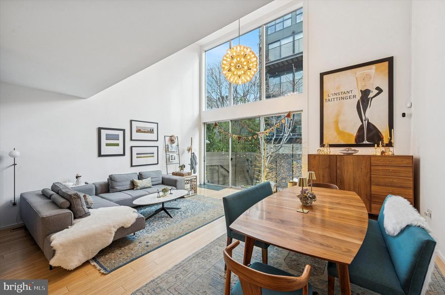 Welcome to 953 N American Street, a 3-story, 3-bedroom, 3.5-bath home offering almost 2,900 square/ft of thoughtfully designed, modern living space in the heart of popular Northern Liberties. Step up through the covered entryway into the slate tiled foyer with custom coat closet. Continue to the main living area featuring bamboo floors that continue throughout, recessed lighting, a convenient half bath, and plenty of space to gather & entertain in this bright & airy space. The kitchen showcases sleek custom cabinetry, quartz composite countertops, high-end appliances, and a center island for prep space and seating for four. The open floor plan continues to a breathtaking 20ft high living & dining room that is flooded with natural light from the soaring 2-story windows with sliding glass doors leading to the private patio & garden. Head up the floating staircase to the 2nd floor mezzanine, open to below, with an eye-catching stone tile surround gas fireplace for cozy evenings at home. Down the hall is a spacious bedroom outfitted with a unique sliding wall panel, giving the opportunity to transform the space into an open-concept living area. Appointed with a double closet, full bath ensuite, and access to a private balcony, it lends itself perfectly to serve as a guest suite or home office. Head up to the 3rd level to find another large bedroom with custom walk-in closet, and ensuite bathroom featuring penny tile flooring, floating vanity, and marble tiled walk-in shower. The primary bedroom offers its own private full-length balcony, Remote operated Shade Store shades, pocket-door custom walk-in closet, pocket-door full bath ensuite with floating vanity, luxurious marble tiled shower/tub combo, and cabinetry offering plenty of storage space. Make your way to the finished daylight basement that provides additional flexible living space, extensive custom storage, and houses the laundry & utilities. Finally, head out back to the aforementioned Japanese inspired slate patio & garden that is truly your own private escape from the hustle and bustle of city living. This home has been lovingly maintained with an impressive list of improvements and features, as a separate attachment above, including a whole house filtered water system and attached carport. Amazing location a few yards from the community owned Liberty Lands Park with private vegetable garden spaces and a brand new children’s playground in progress. Just blocks from an array of local dining & fooderies, popular coffee shops, and close to dog parks and other pet amenities. All this with easy access to Center City, Rt 676 & 95, and the Spring Garden Station. You don’t want to miss the opportunity to call this gorgeous house, HOME. Schedule your private tour today!