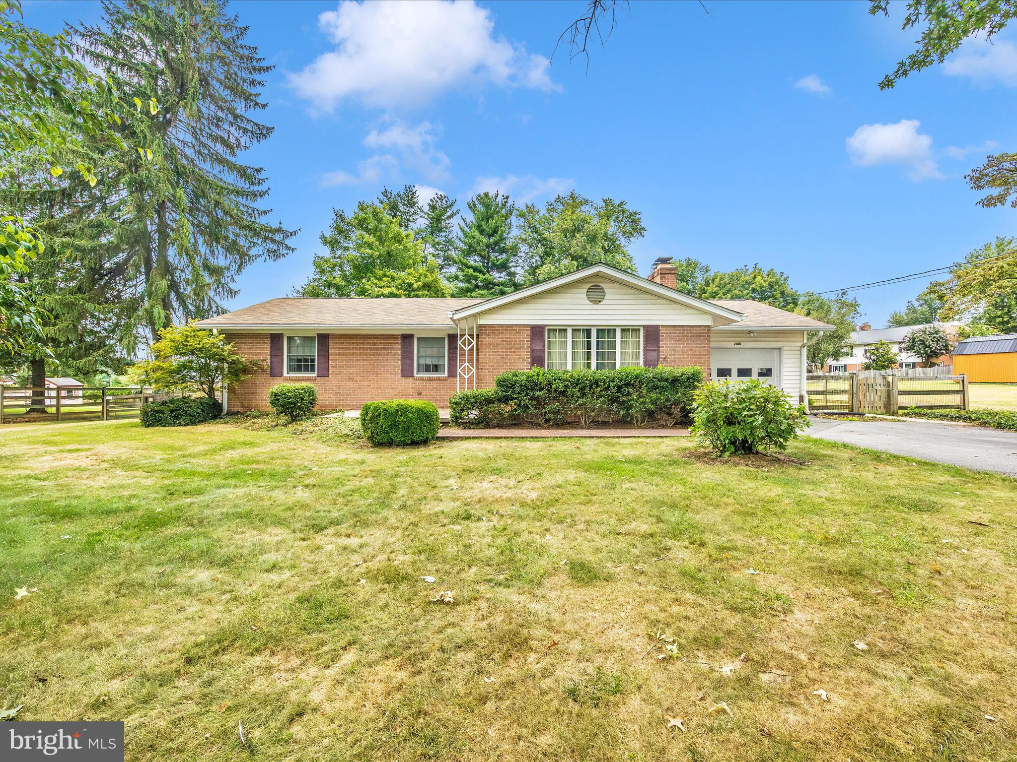 Charming All-Brick Ranch in a Sought-After Neighborhood! This well-maintained home features beautiful oak hardwood floors throughout the main level, 3 spacious bedrooms, and 2 full baths. Central A/C and a wood-burning fireplace in the living room. There is a large 3-season room attached - tons of light and access to the huge back yard. The lower level is mostly finished with plenty of space for storage and a current workshop area. This half-acre lot provides endless possibilities—add a pool, build an addition, or create the ultimate play space. Two huge sheds convey. Located in a quiet, desirable community with no city taxes and no HOA fees. This is the perfect blend of charm, convenience, and potential! USDA eligible location! Appraised by Six, McClain & Assoc. Professional pictures coming Tuesday, the 19th.