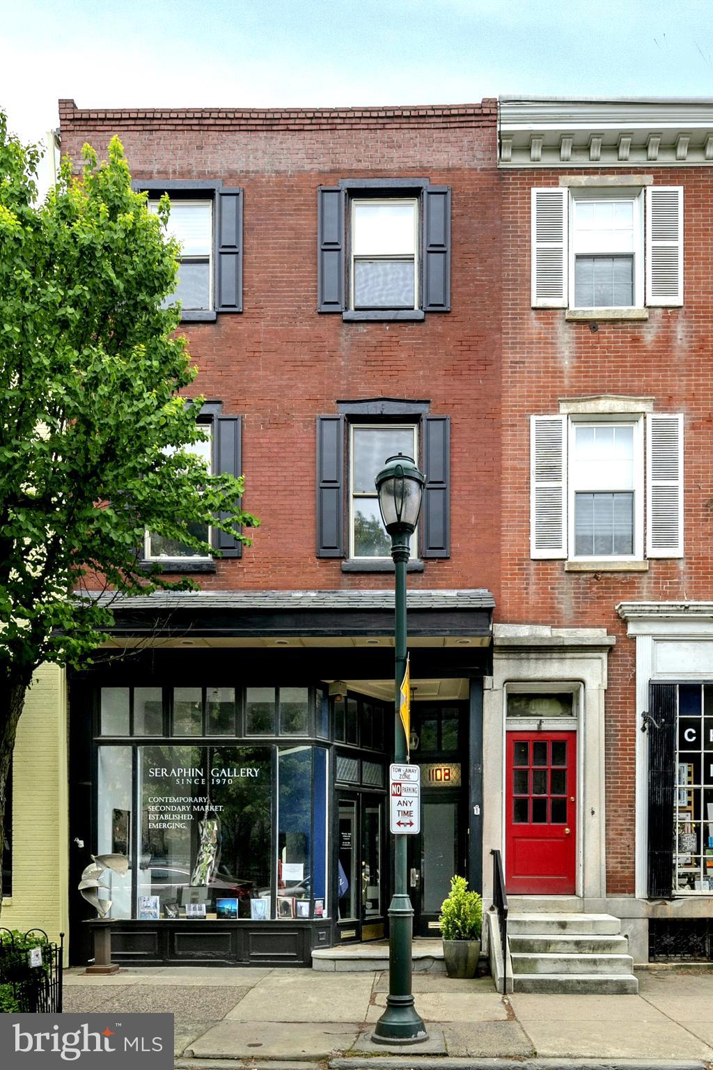 Large multifamily commercial property for sale in the heart of the Historic Pine Street Shopping District (Historic Antique Row) in Washington Square West. The property is one of the few that directly faces Louis Kahn Community Park. The building has one of the best commercial retail spaces in the area and it currently operates as an internationally recognized art gallery. The first-floor retail space has 14' ceilings and two gallery spaces that can be opened up to a continuous space without columns. There is currently an office and bathroom at the back of the space and a sculpture garden behind the building. There are two flights of interior stairs to the basement and a Bilko style door with stairs in the rear garden. The rear interior staircase to the basement is very wide and this level has high ceilings that can be added to the retail space. It is currently used for art storage and framing. The top two levels of the building contain four one-bedroom apartments. The building has been well maintained. The furnace was replaced last winter, a new tenant laundry room was added to the third floor and two of the apartments have been newly upgraded. The building is in the middle of a major shopping district with great foot and automobile traffic. There are multiple public transportation options within a block and multiple off-street parking options within 3 blocks.
