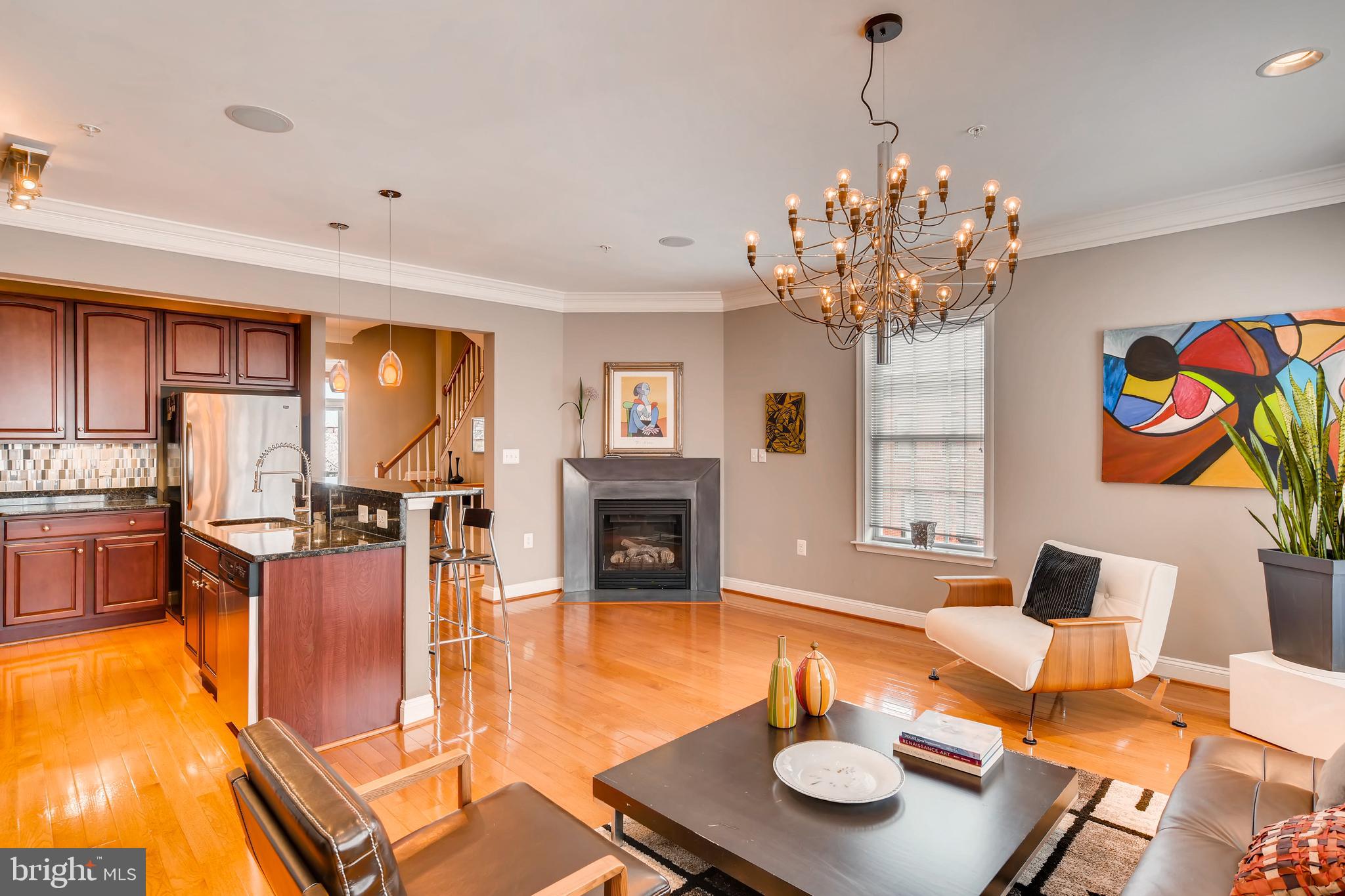 4 Stories of Luxury awaits in this light filled 2,550 square foot end of group home. Some of the amazing features you will experience are: Wood floors throughout , whole house audio system, 2 car garage, entertaining loft with wet bar and entry to the huge roof deck with city skyline and water views, the grand master has an on-suite and professionally organized walk in closet. The gourmet kitchen with island and gas fireplace are sure to please along with the landscaped front yard which is rare to find in Canton. This really is a special one of a kind style home and you owe it to yourself to make it your home of choice today.
