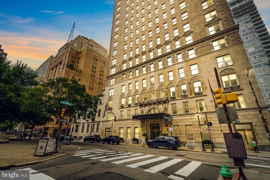 Make your home on storied Rittenhouse Square in this expansive three-bedroom residence featuring breathtaking park views, an elegant layout, and coveted original details at The Barclay, a historic full-service condominium. Bring your designer and transform this exquisite apartment into your magnificent dream home in Philadelphia's most sought-after neighborhood. Spanning 2,800 square feet, this high-floor showplace welcomes you inside with tall ceilings and herringbone hardwood floors trimmed with tall baseboards and double-crown molding. Rows of windows along the northern and western exposures add glorious natural light while framing iconic views of the square and city skyline. An impressively grand entry gallery flows to a large living room with a stately marble fireplace, a wall of built-in cabinetry, and spectacular sunset and treetop vistas. The large dining room accommodates lavish dinner parties beautifully, while a convenient butler's pantry opens to the windowed kitchen, where you'll find a generous footprint for the gourmet wonderland of your dreams. A guest bathroom and large laundry room add excellent convenience to this wing. Head to the primary suite to discover two roomy closets and an en-suite bathroom. Two spacious and bright secondary bedrooms enjoy walk-in closets and a lovely windowed Jack-and-Jill bathroom with an oversized shower and pedestal sink. Additional closet space completes this remarkable Rittenhouse gem awaiting your personal touch.
Built in 1928, The Barclay is a handsome neo-Adam brick and limestone building. Architect J.E.R. Carpenter designed many notable New York City high-rises and is best known for his work on the Empire State Building. The Barclay served as an elegant hotel until 1982 and was converted to condominium use in 1999. Today, residents of the pet-friendly building enjoy a regal lobby, concierge/doorman service, on-site management, a fitness center, access to a chauffeur-driven Mercedes S-class and Stephen Starr's Barclay Prime steakhouse on the ground floor. From this outstanding Rittenhouse Square location, you're surrounded by the centerpiece park and renowned Center City shopping, dining, and nightlife, including The Shops at Liberty Place. Philadelphia's best historic sites, museums, and cultural institutions are all within easy reach, and nearby bus, PATCO, and Amtrak service provide easy access to the rest of the city and beyond.